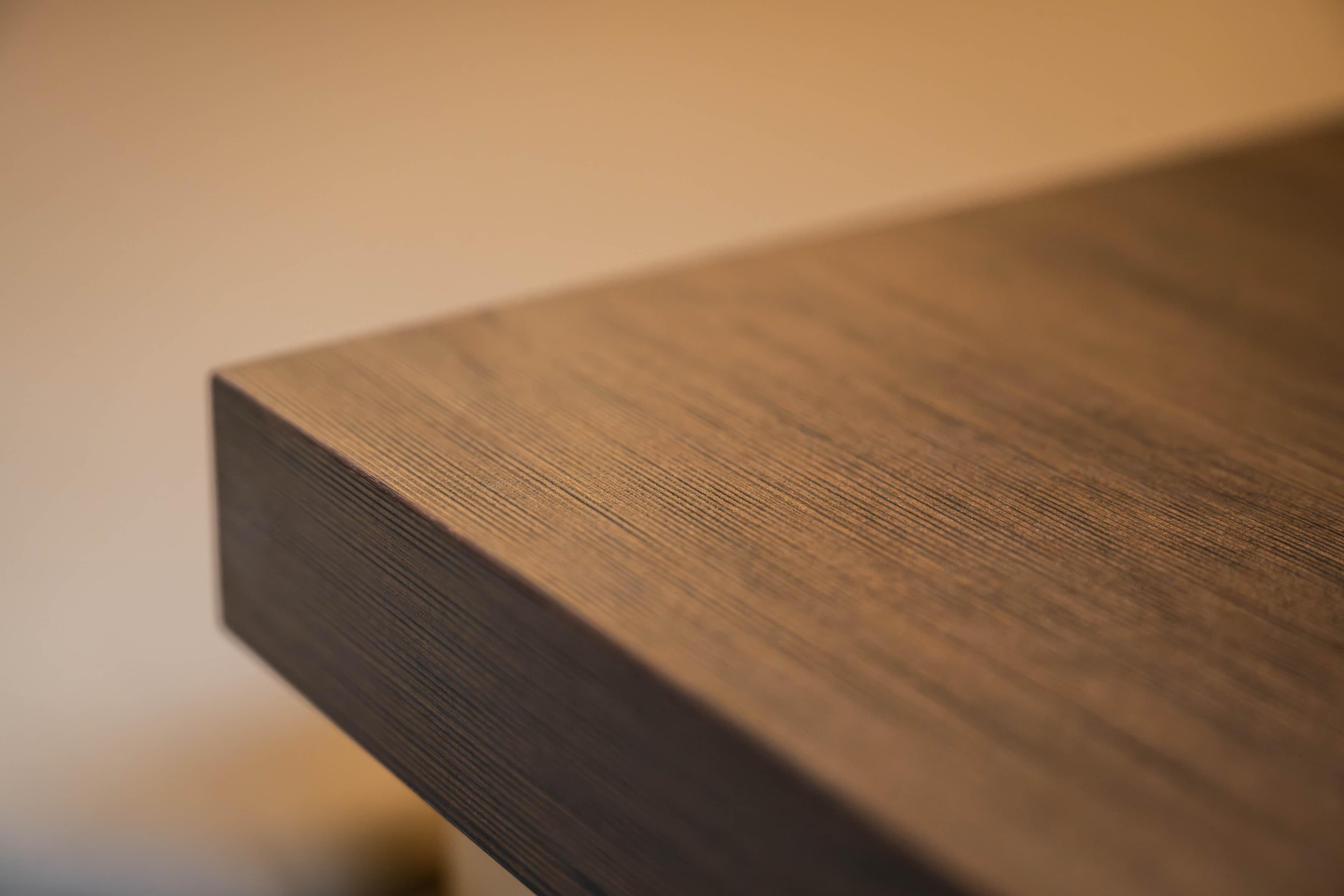 Close-up of a wooden surface, showcasing fine grain texture and smooth finish.