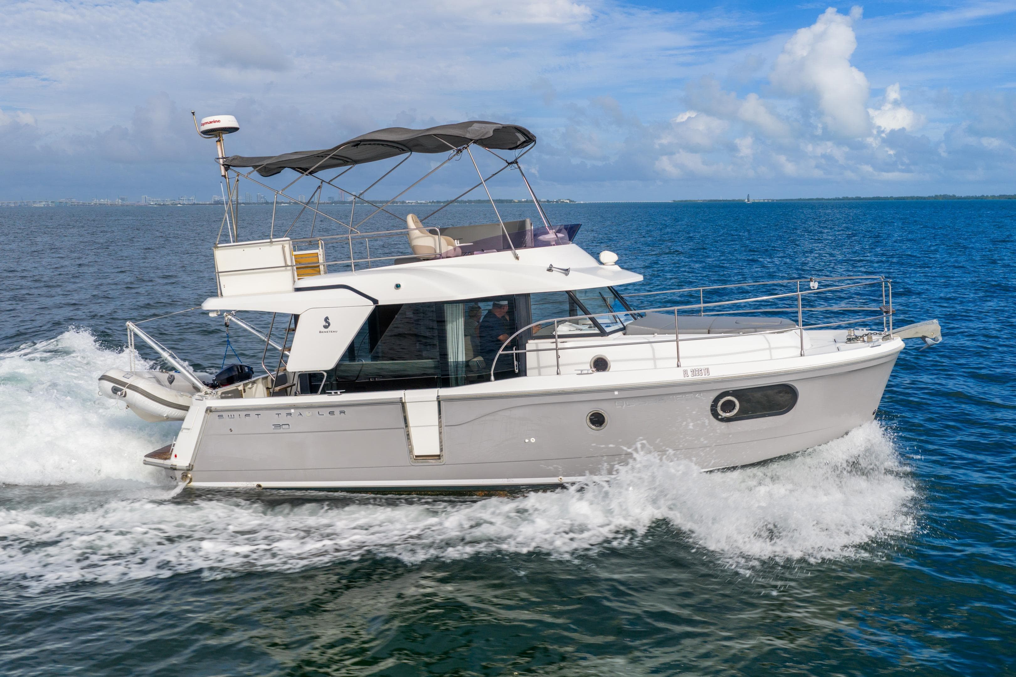 2017 Beneteau Swift Trawler 30 cruising on open water under a clear sky.