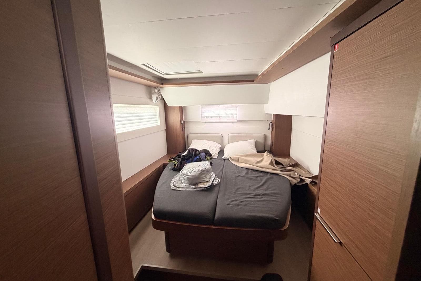 Interior cabin of a 2021 Lagoon 46 yacht with a cozy bed setup.