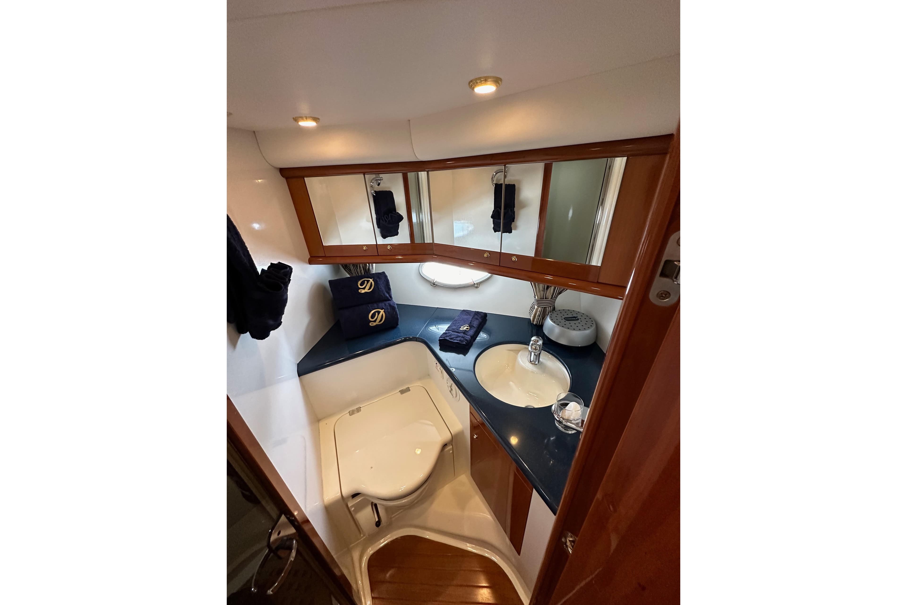 Luxurious bathroom in 2000 Sunseeker Predator 60 yacht with elegant fixtures and wood accents.