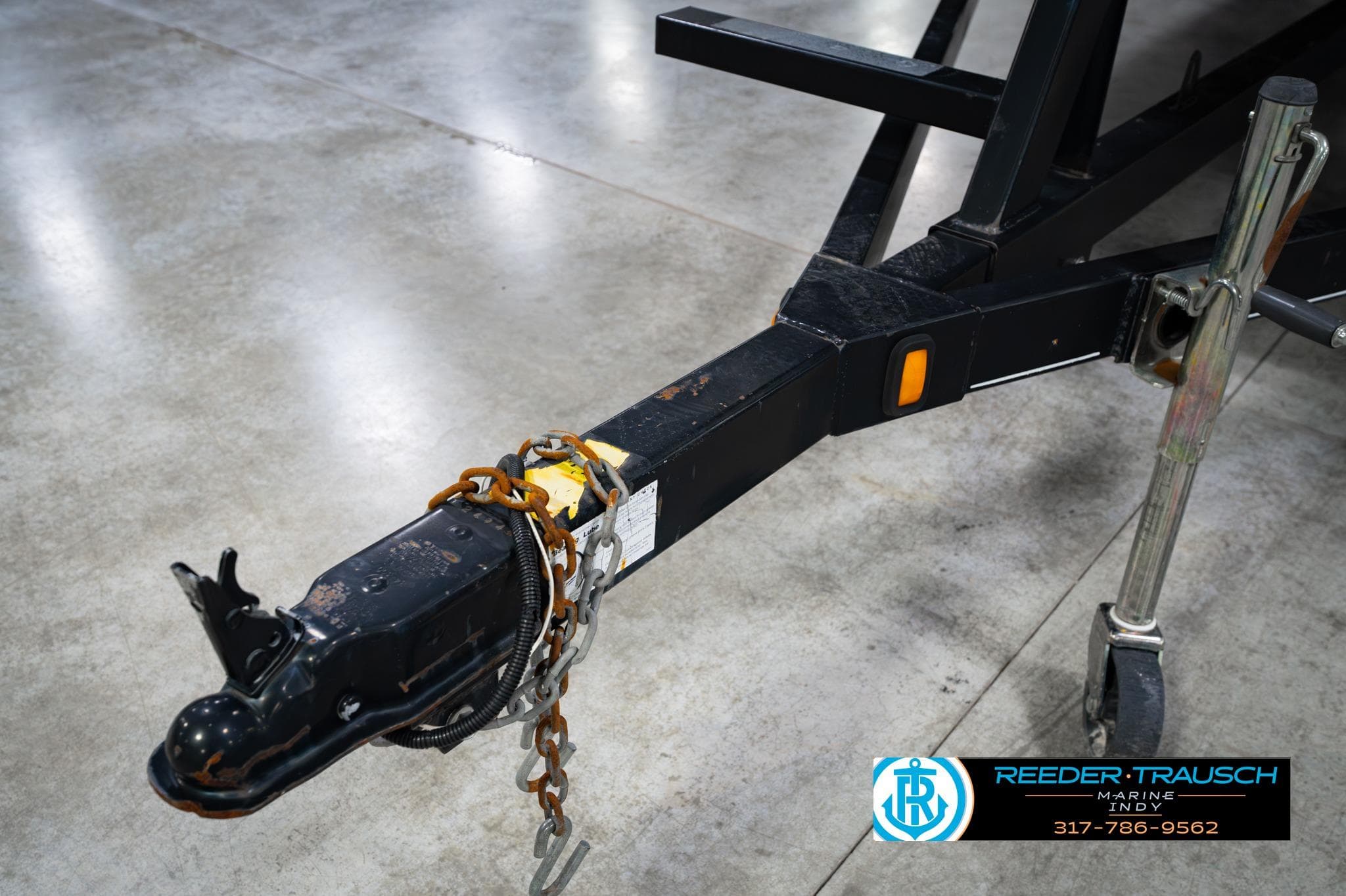 Trailer hitch of a 2006 Bennington 21L Sedona on concrete floor.
