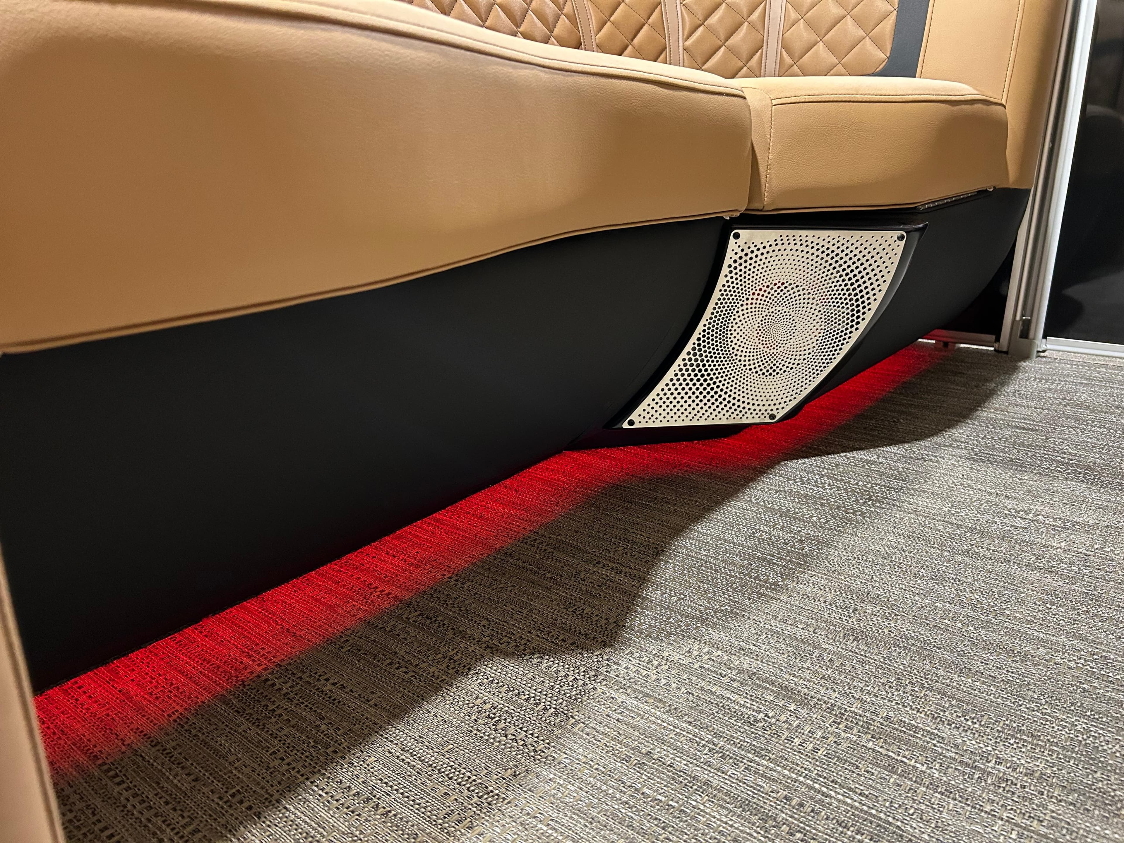 2025 Godfrey Aqua Patio 235 ULC interior with ambient red lighting and cushioned seating.