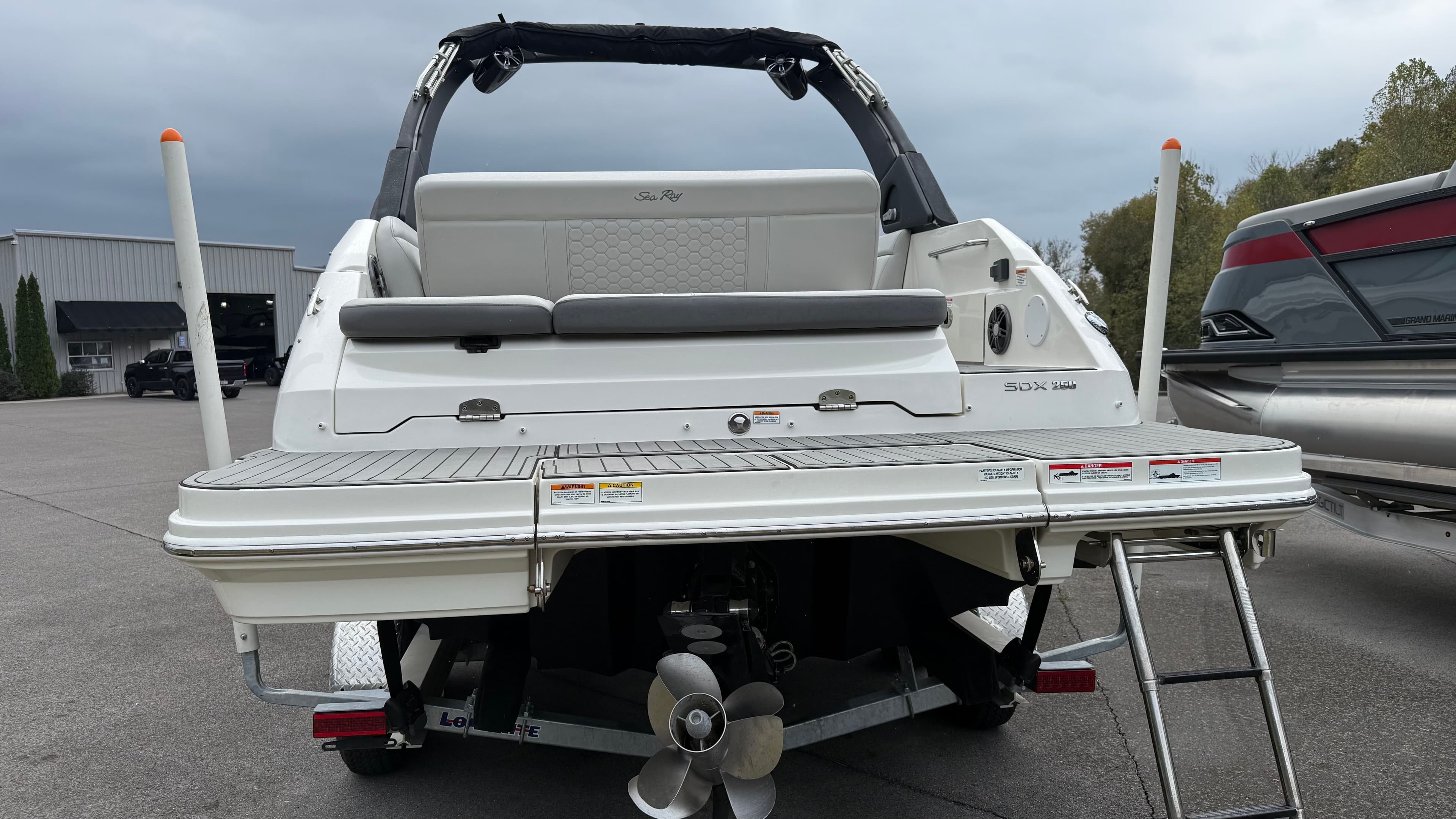 Rear view of a 2021 Sea Ray SDX 250 boat on a trailer.