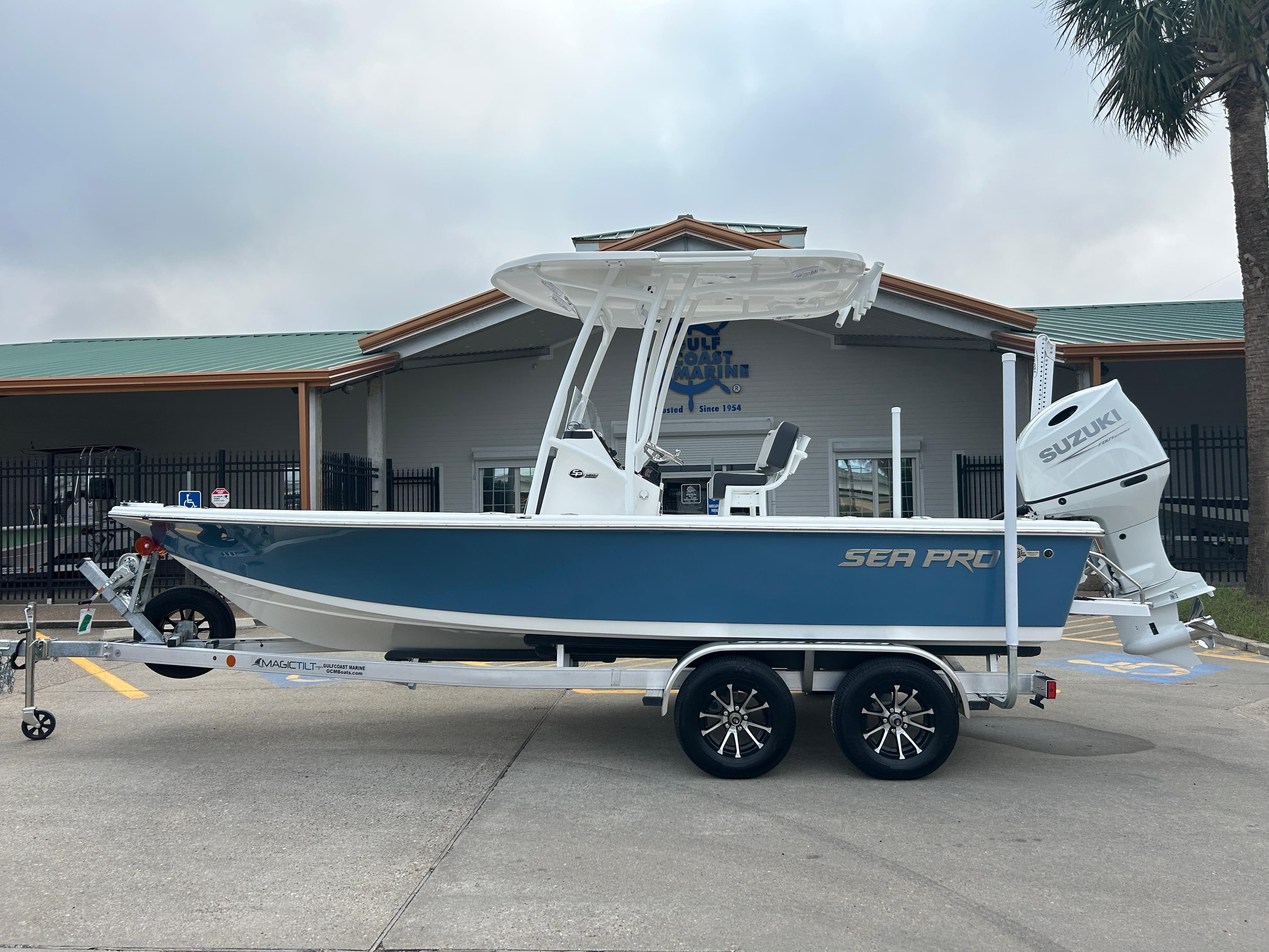 2025 Sea Pro 210 Bay boat on trailer, blue hull, Suzuki outboard motor.