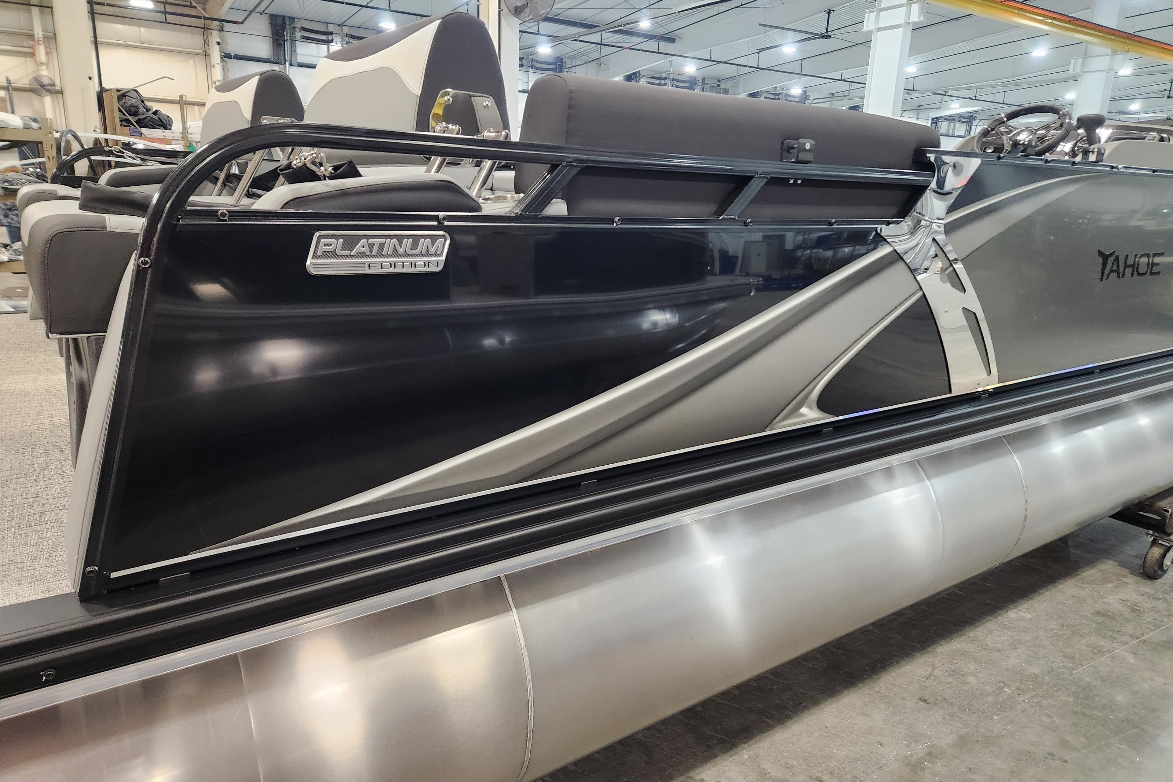 2026 Tahoe Pontoon 23 LTZ Quad Lounge, Platinum Edition, sleek design in a showroom setting.