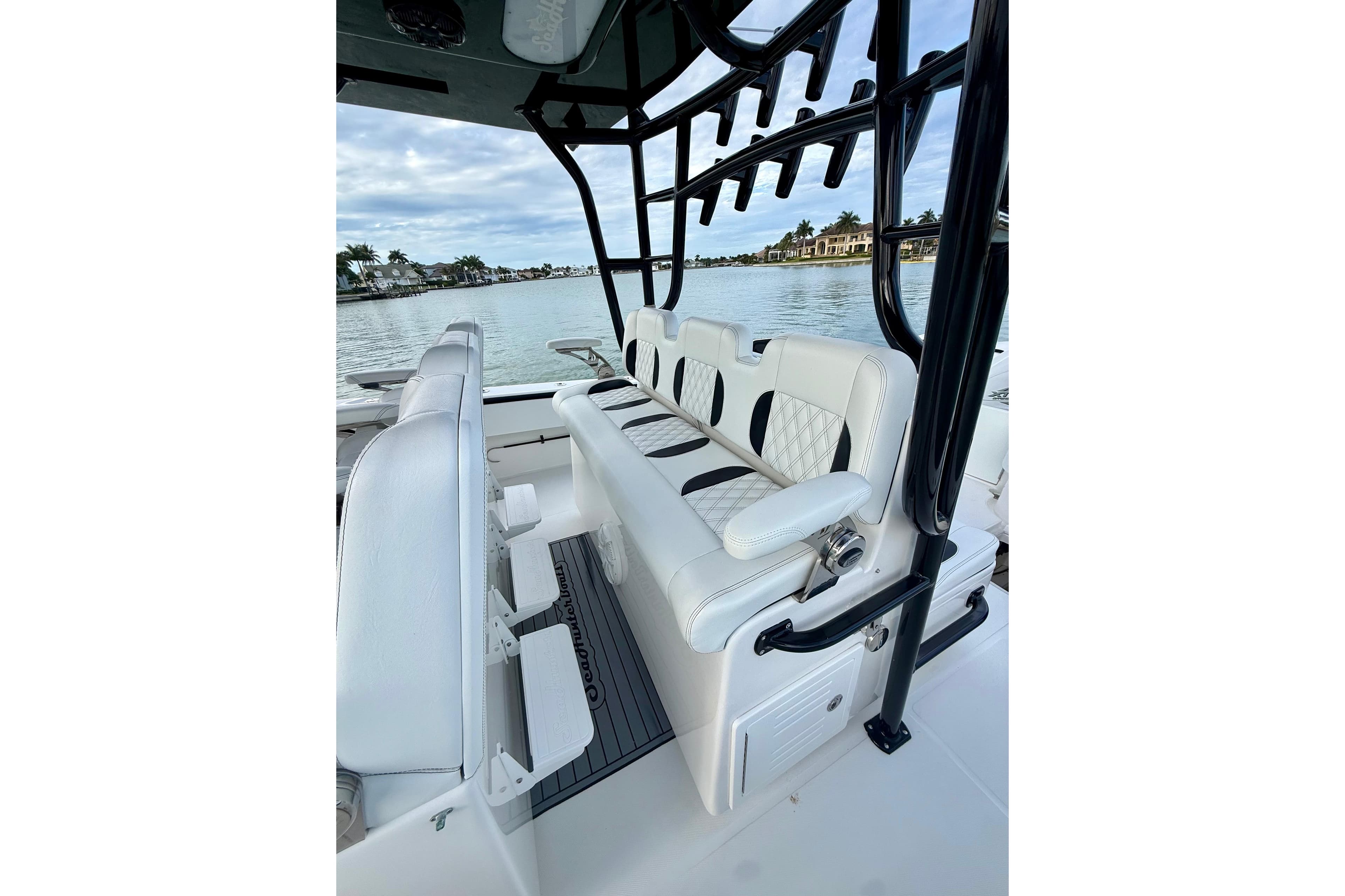 2020 SeaHunter 41 CTS boat interior with luxurious white seating and scenic waterfront view.