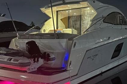 2014 Beneteau Gran Turismo 49 yacht docked at night with illuminated interior.