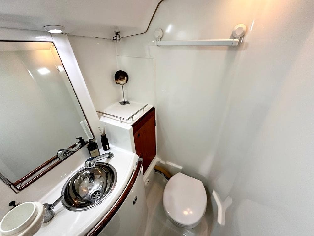 Bathroom interior of a 1996 Beneteau 50 yacht, featuring sink and toilet.
