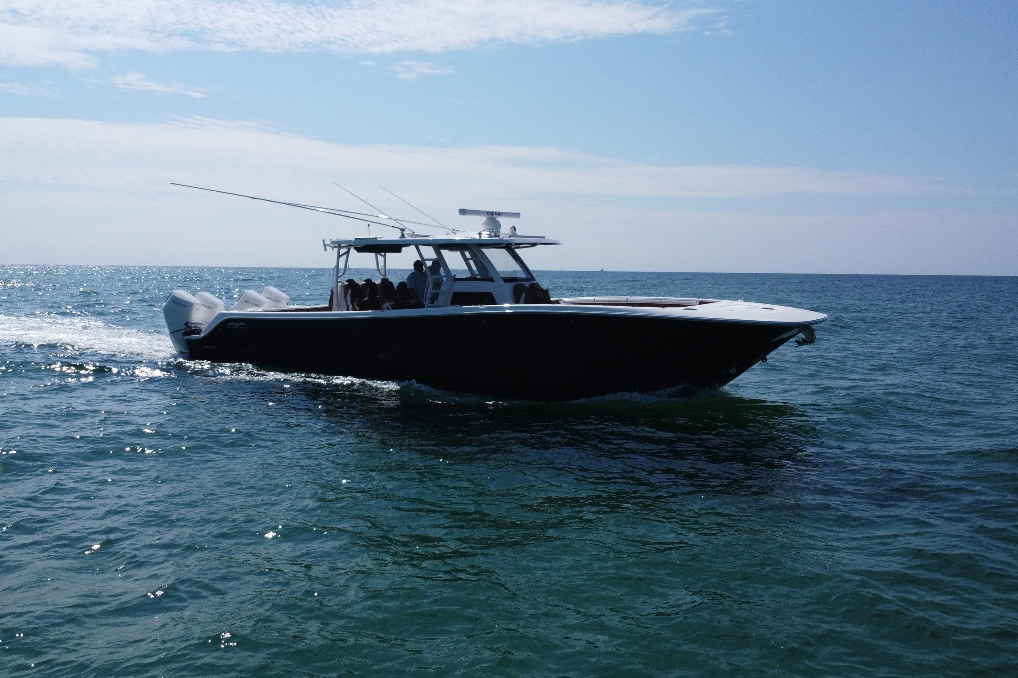 2024 Invincible 46 Catamaran cruising on open water under clear skies.