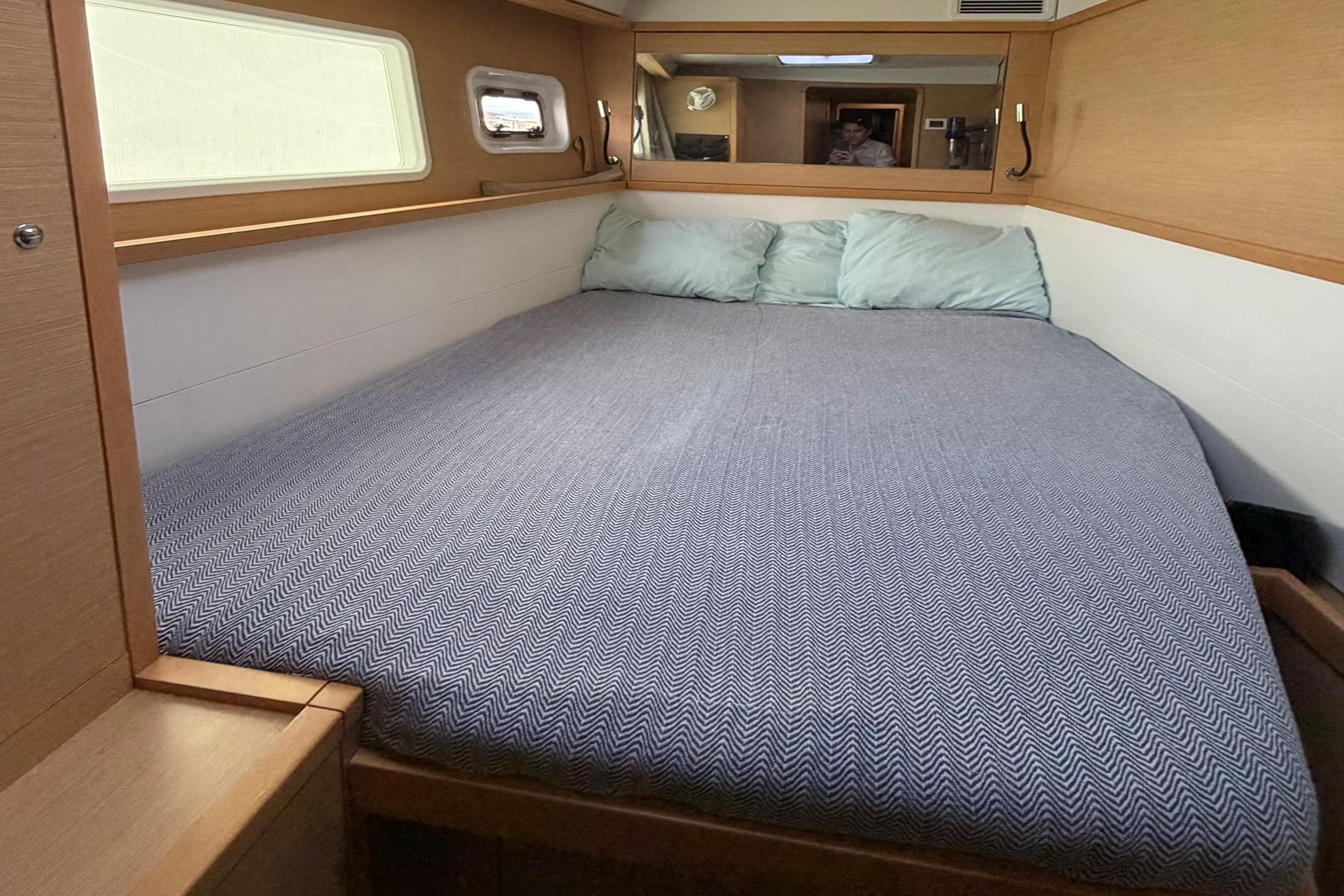 Cozy cabin interior of 2018 Lagoon 450 catamaran with comfortable bed and soft pillows.