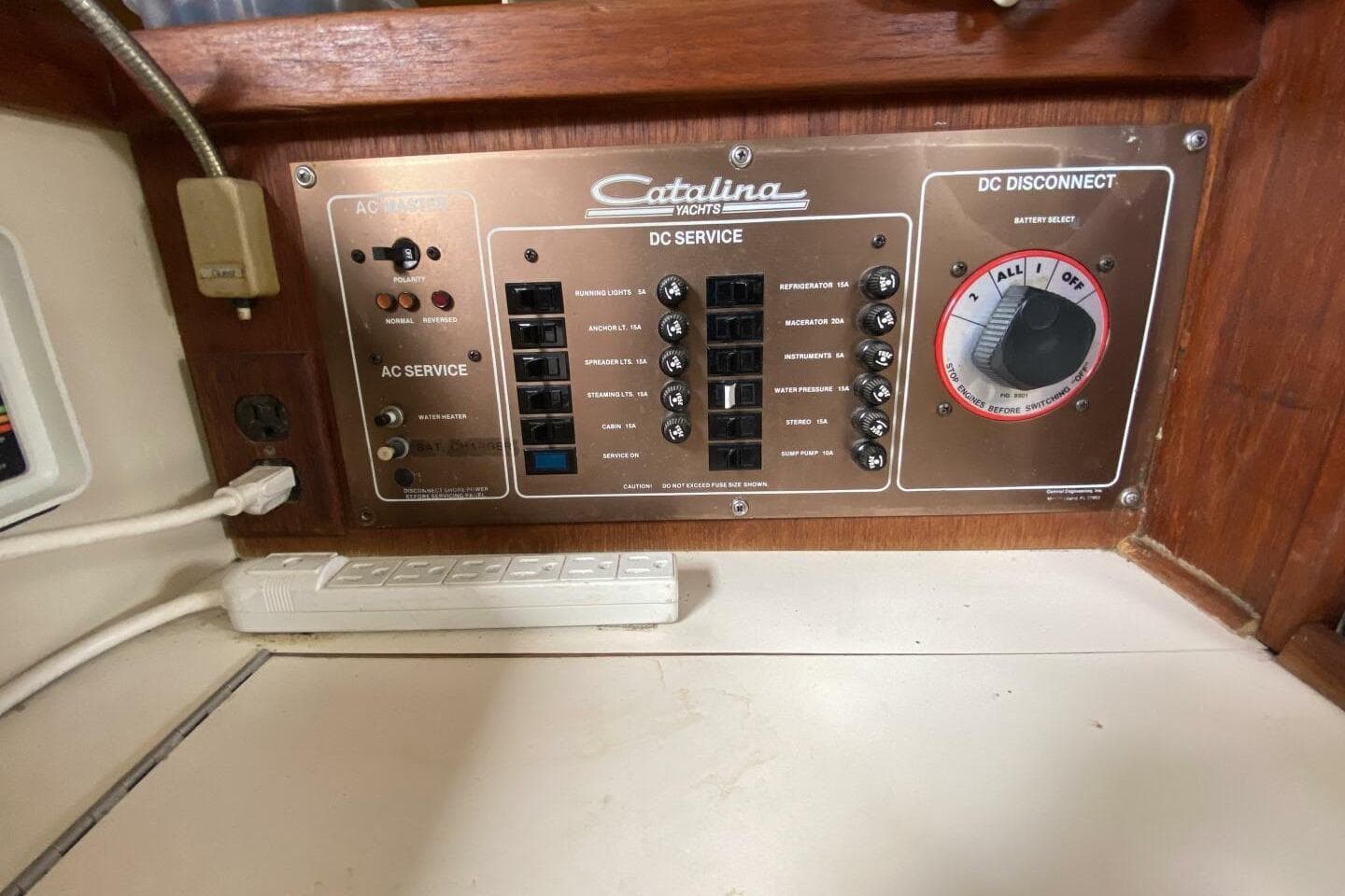Electrical panel of a 1986 Catalina 34 yacht, featuring AC and DC service controls.