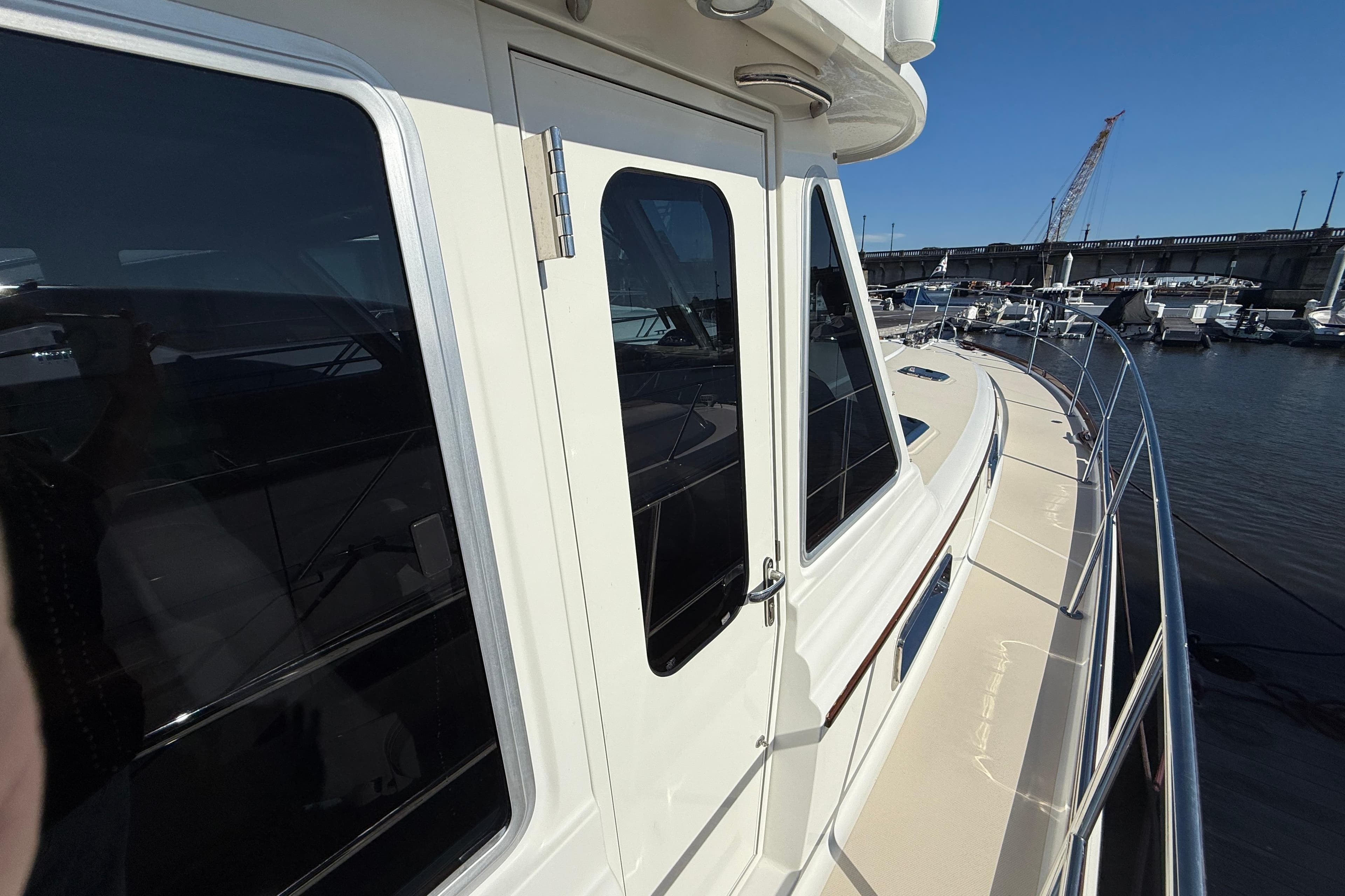 2017 Sabre 48 Salon Express yacht docked at marina, showcasing sleek design and windows.