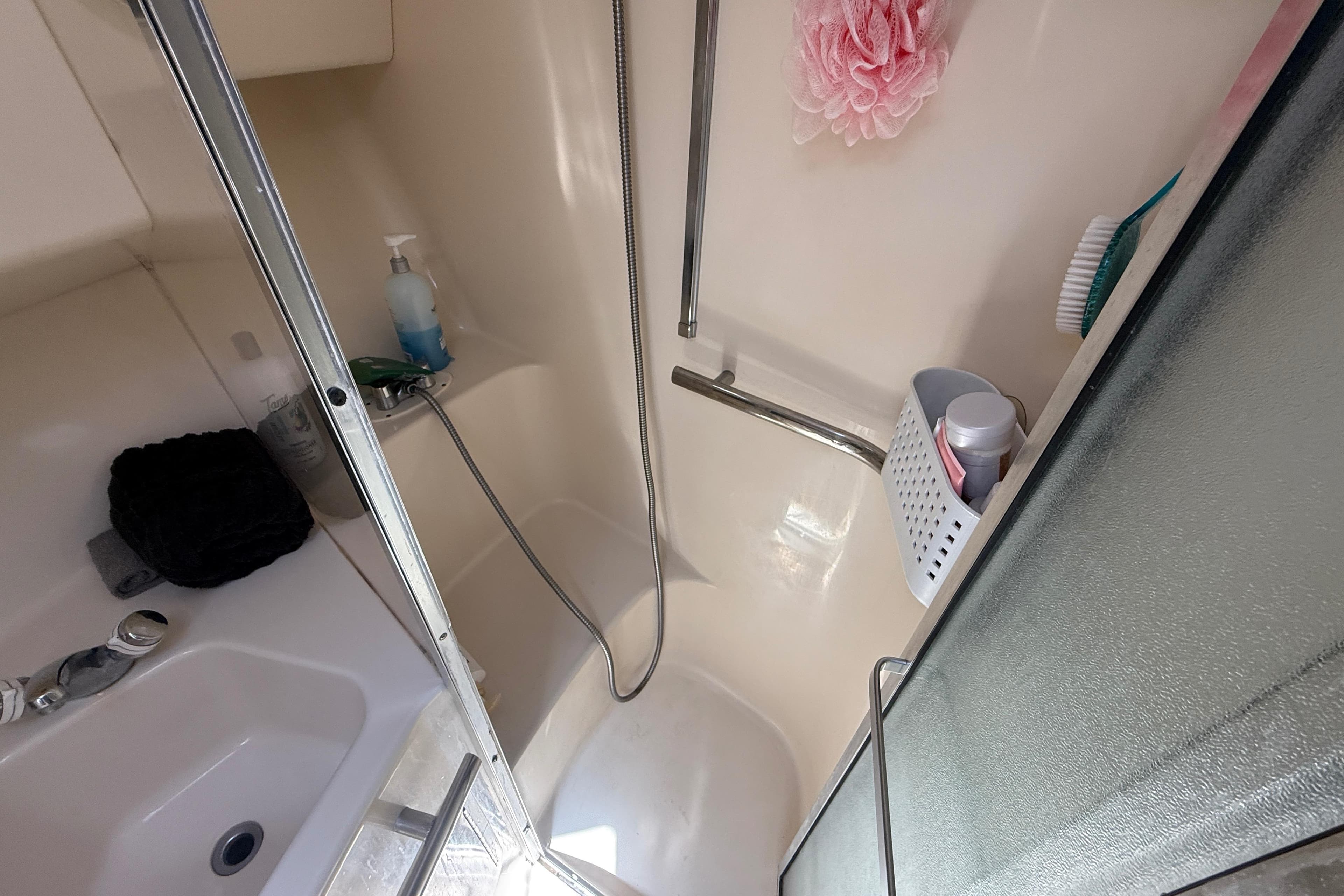 Bathroom of 1996 Sea Ray 400 Express Cruiser with shower and toiletries.