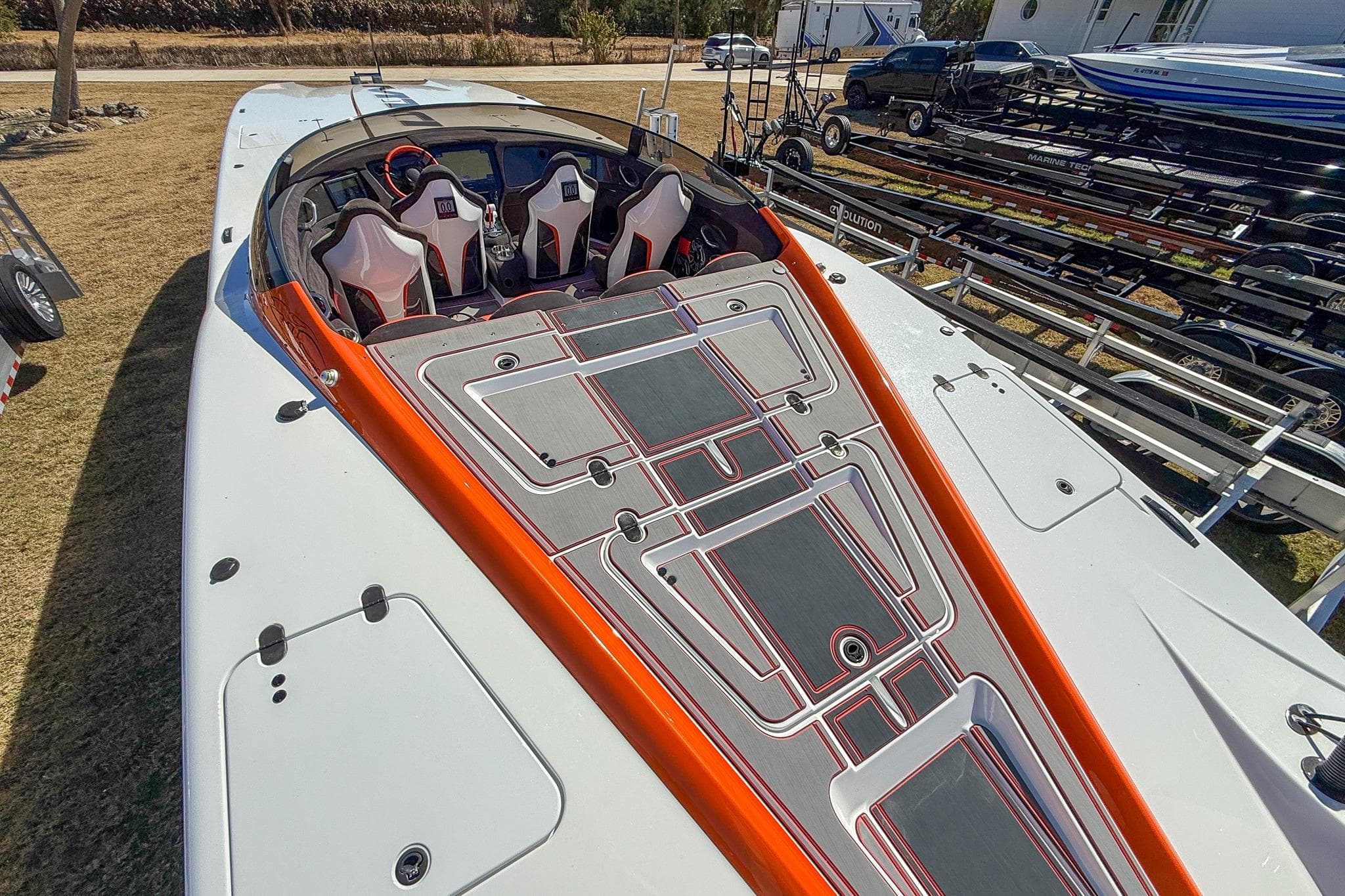 2021 MTI 390X powerboat with sleek design, orange accents, and modern seating arrangement.