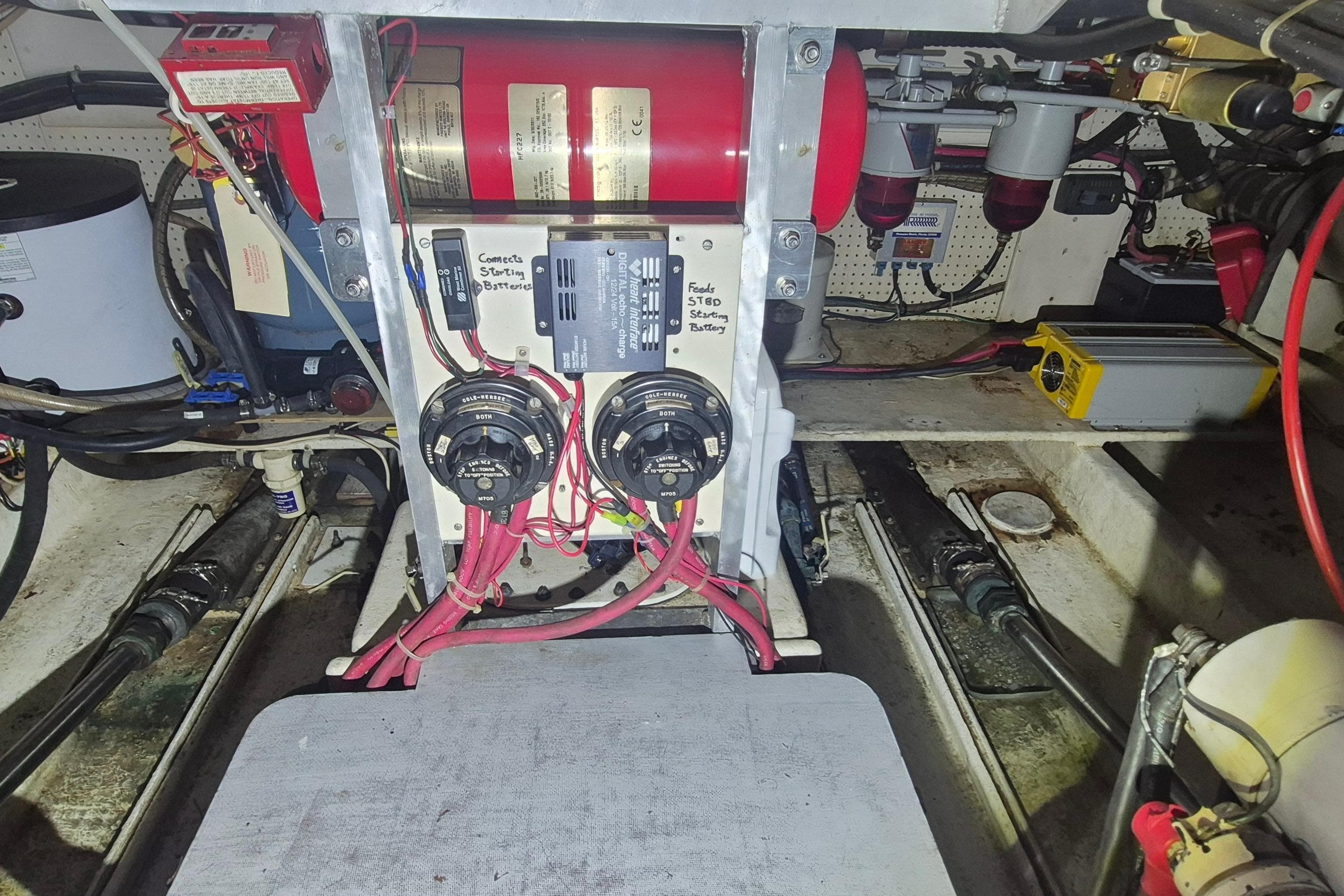 Engine room of 1988 Custom Holland Wesmac-Foley Flybridge Cruiser with electrical components and wiring.