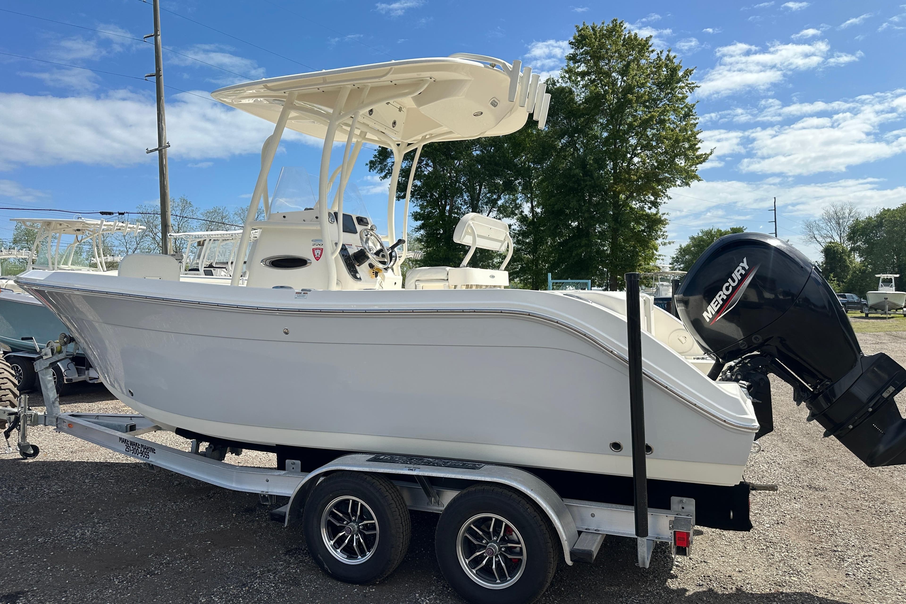 2022 Cobia 220 Center Console boat on trailer with Mercury outboard motor.