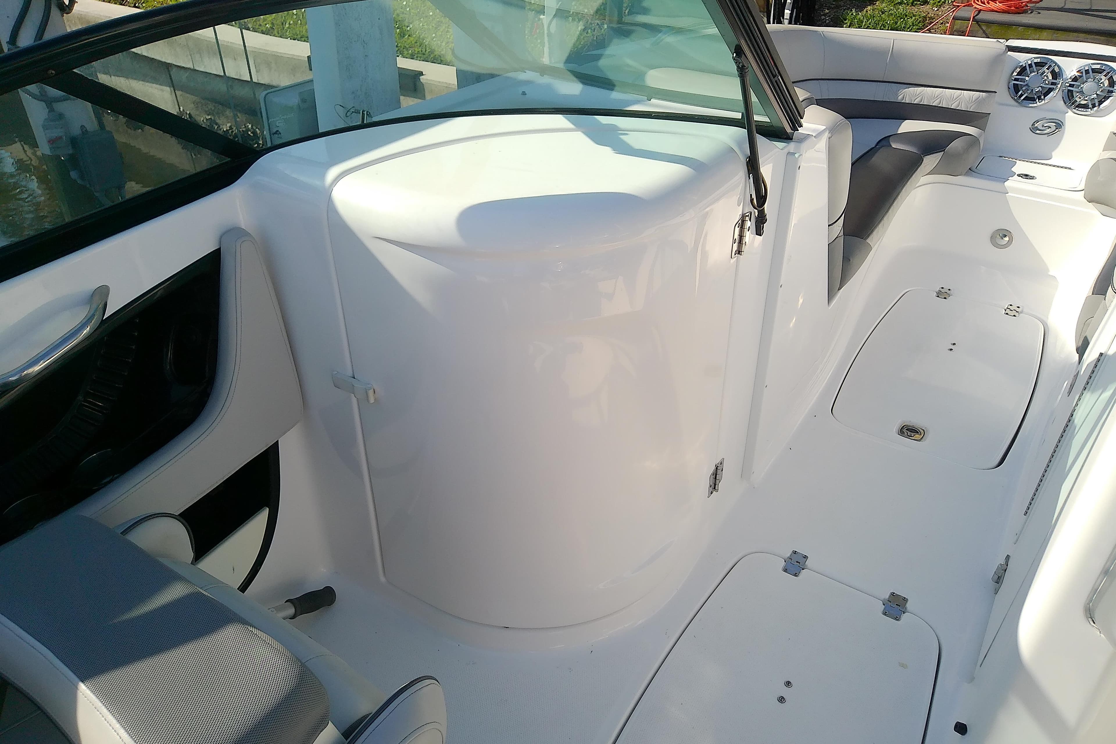 2021 Hurricane SunDeck 2410 OB boat interior with seating and storage compartments.