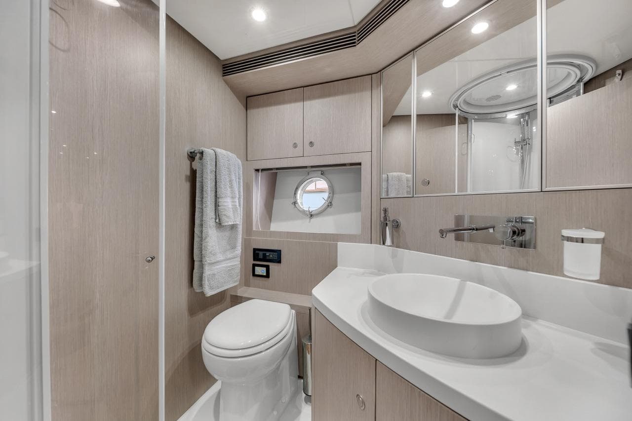 Luxurious bathroom in 2015 Riva 63 yacht with modern fixtures and elegant design.