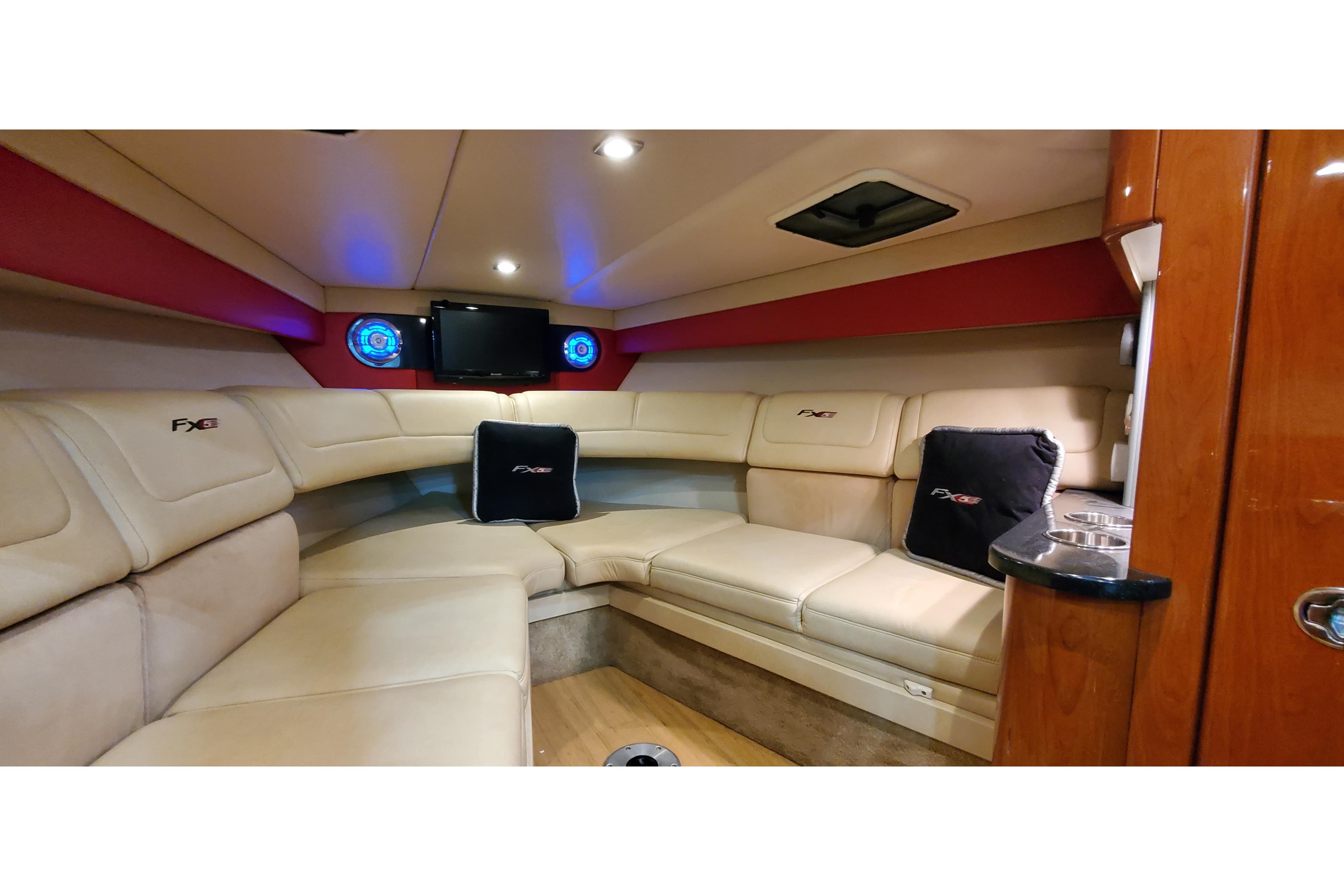 Luxurious interior of 2011 Formula 310 FX5 boat with plush seating and entertainment system.
