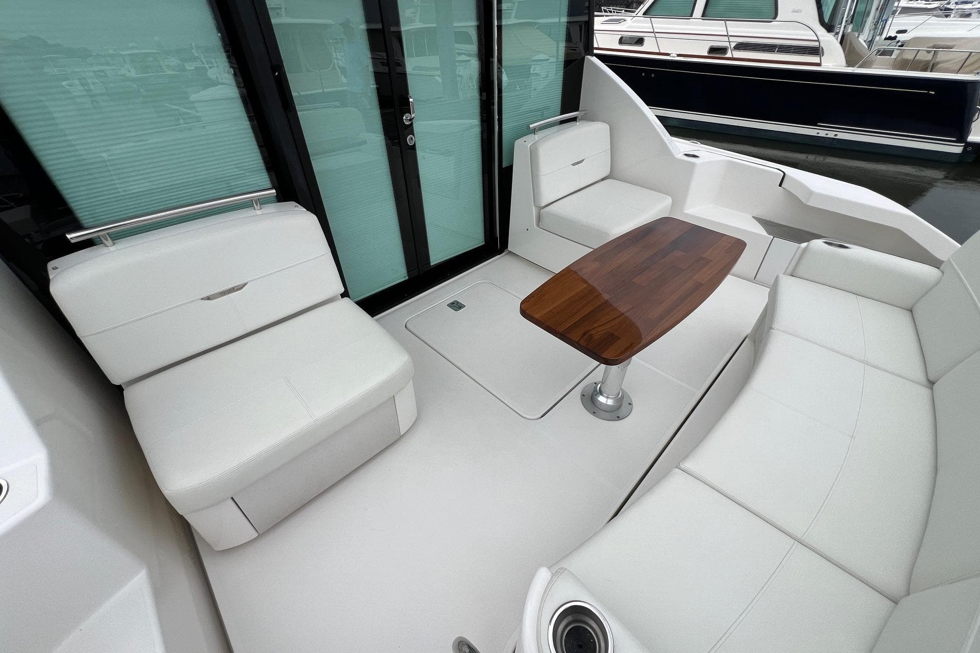 Luxurious 2023 Tiara Yachts C44 Coupe interior with elegant seating and wooden table.