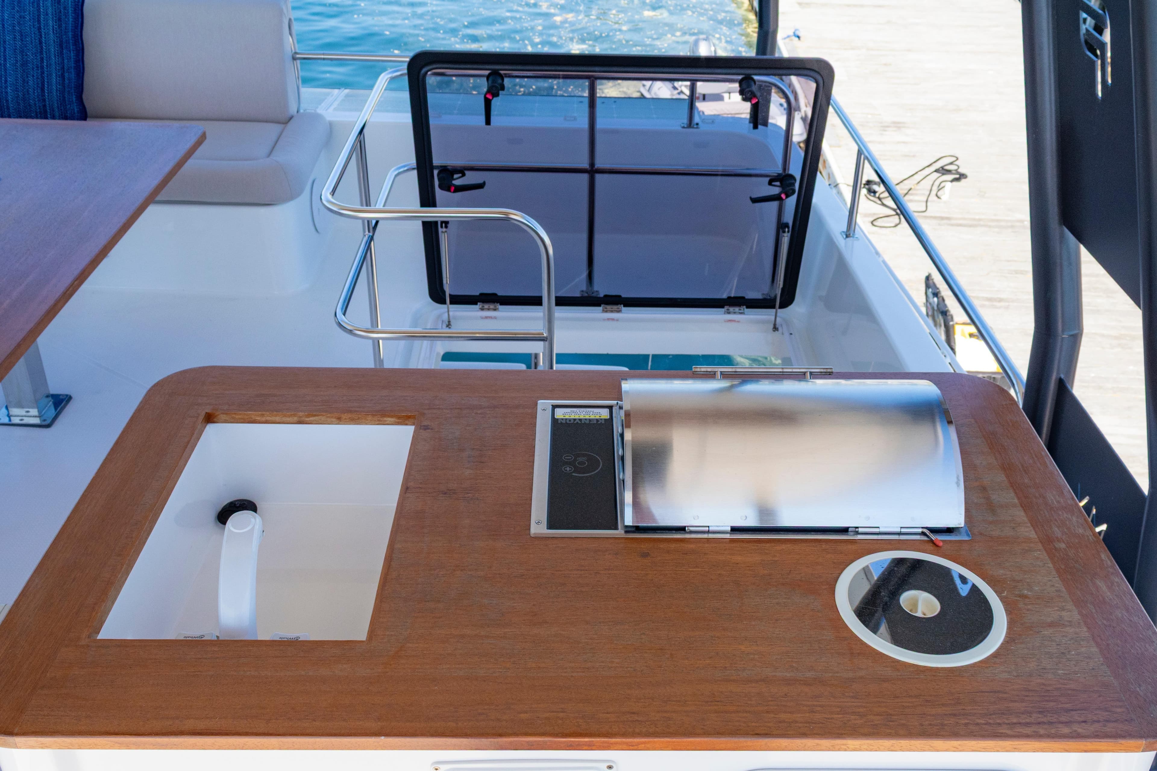 Outdoor kitchen area on 2024 Fountaine Pajot MY5 yacht, featuring a sink and grill.