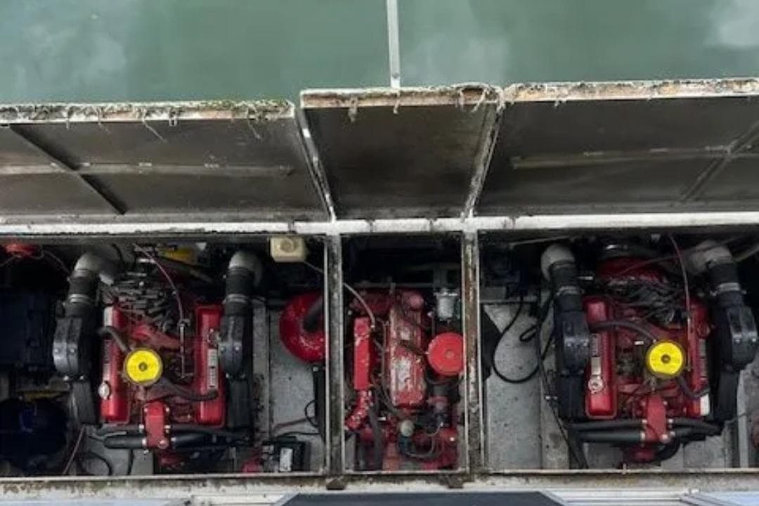 Engine compartment of a 1981 Lazy Days 50 boat, featuring dual red engines.