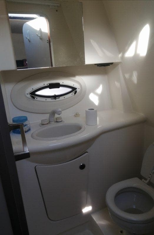 Bathroom interior of 2006 Bayliner 265 boat with sink and toilet.