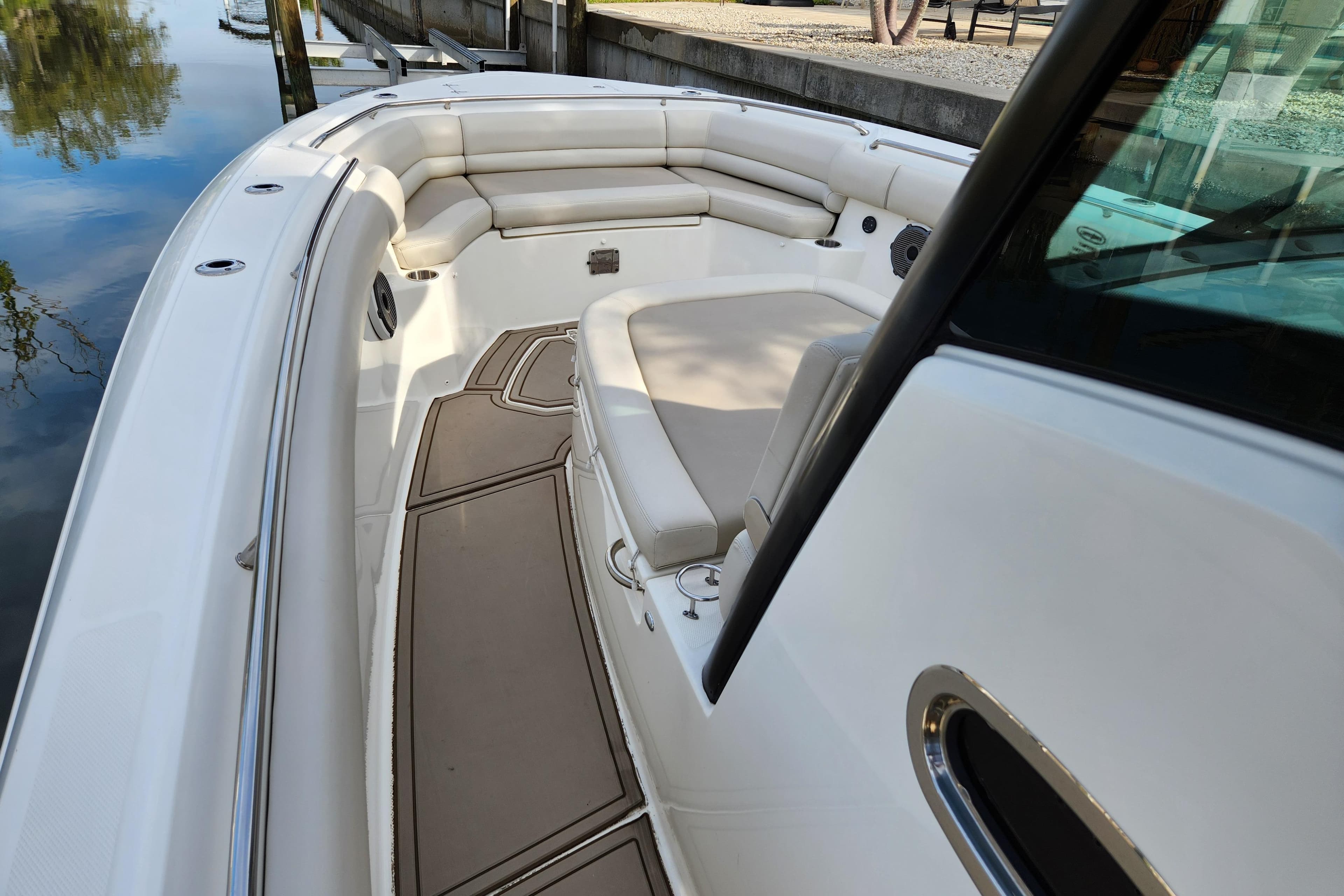 2022 Boston Whaler 330 Outrage boat interior with cushioned seating and sleek design.