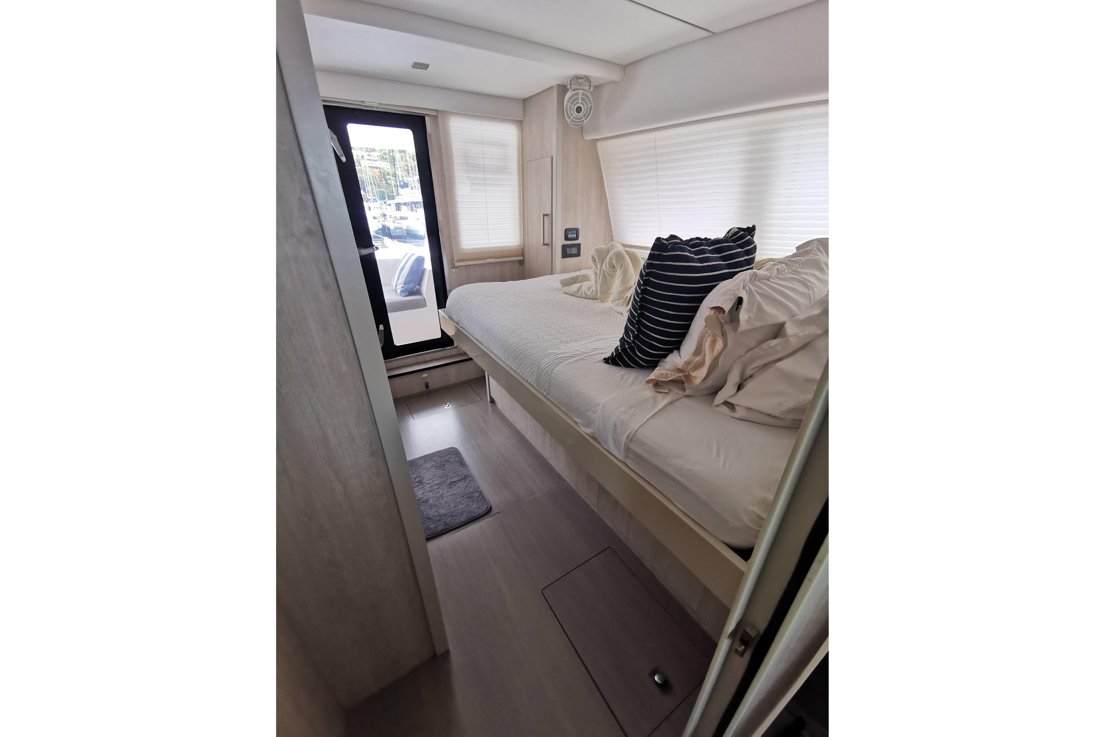 Luxurious bedroom interior of 2020 Leopard 58 yacht with modern decor and natural light.