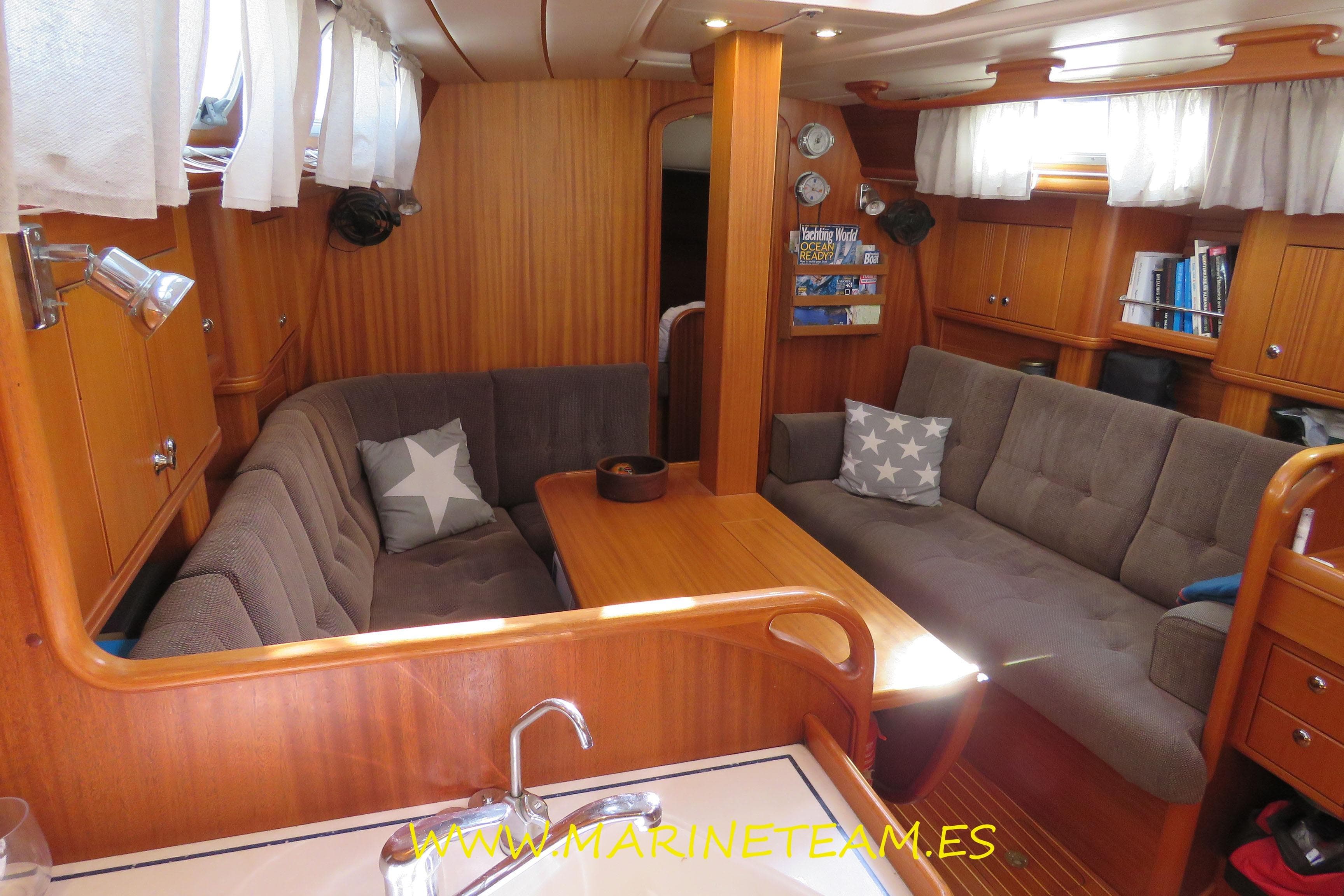 Cozy interior of 2002 Najad 373 yacht with wooden finish and comfortable seating.