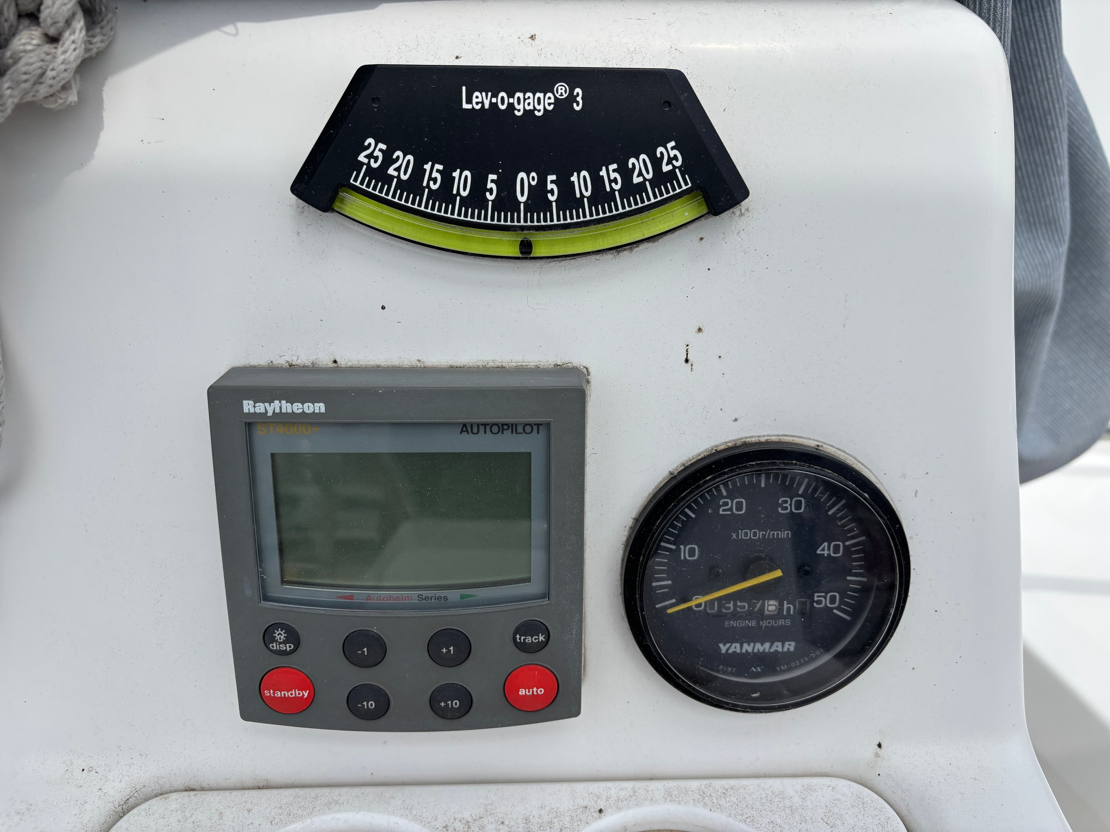 Control panel of a 2001 Hunter 320 sailboat with autopilot and engine gauges.