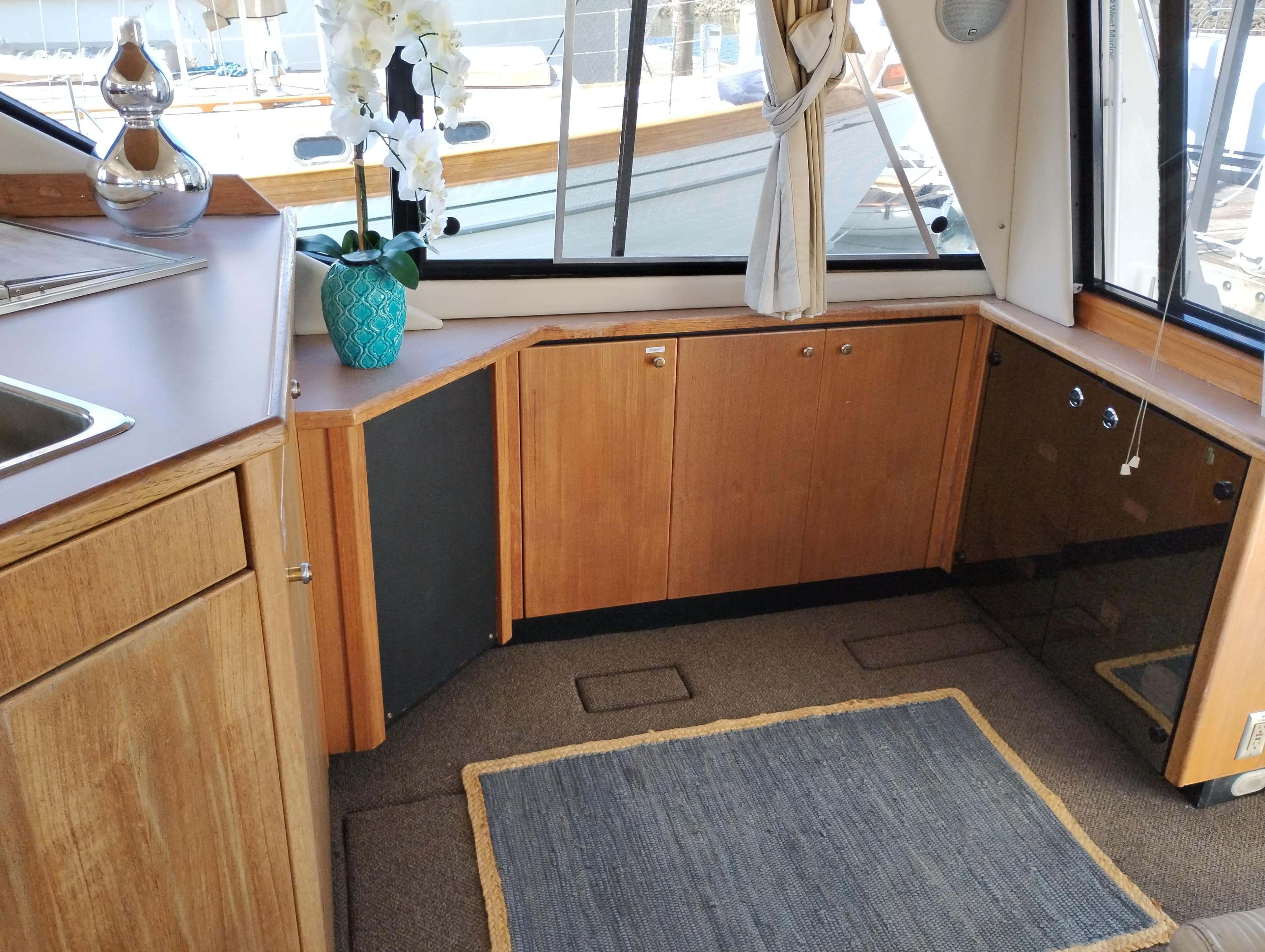 1997 Bayliner 3988 Motor Yacht interior with wood cabinetry and large windows.