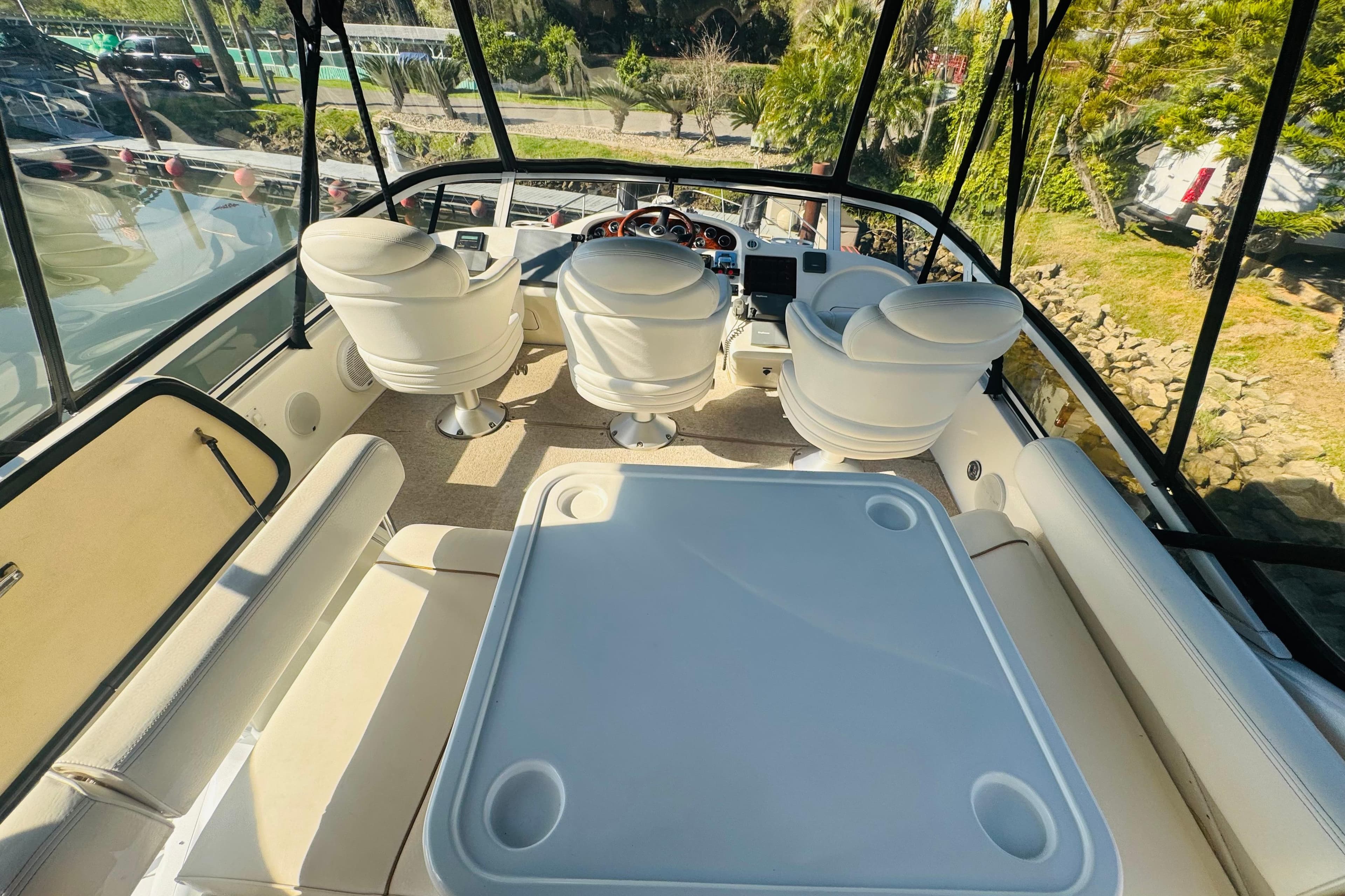 Interior view of 2000 Sea Ray 400 Sedan Bridge yacht with seating and helm.