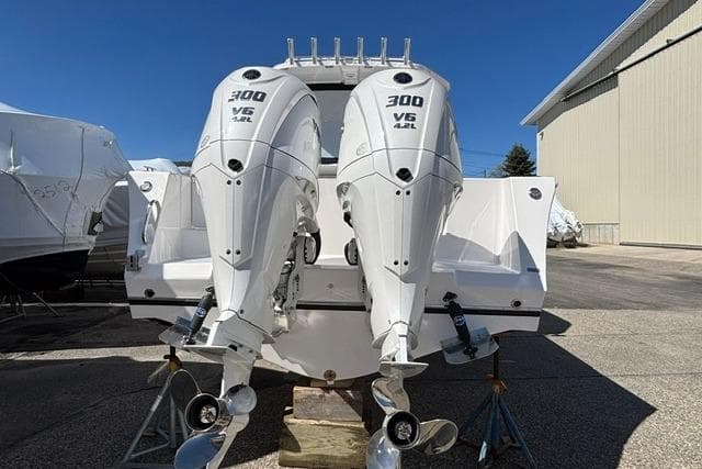 2026 NorthCoast 285 HT boat with dual 300 V6 outboard engines, docked outdoors.