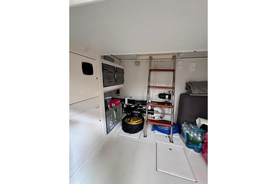 Interior storage area of a 2022 Nordhavn 41 boat with ladder and supplies.