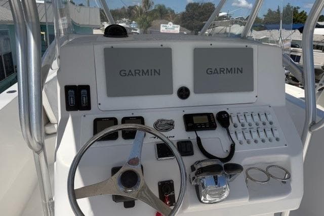 2005 PROLINE Super Sport boat dashboard with Garmin navigation systems and steering wheel.
