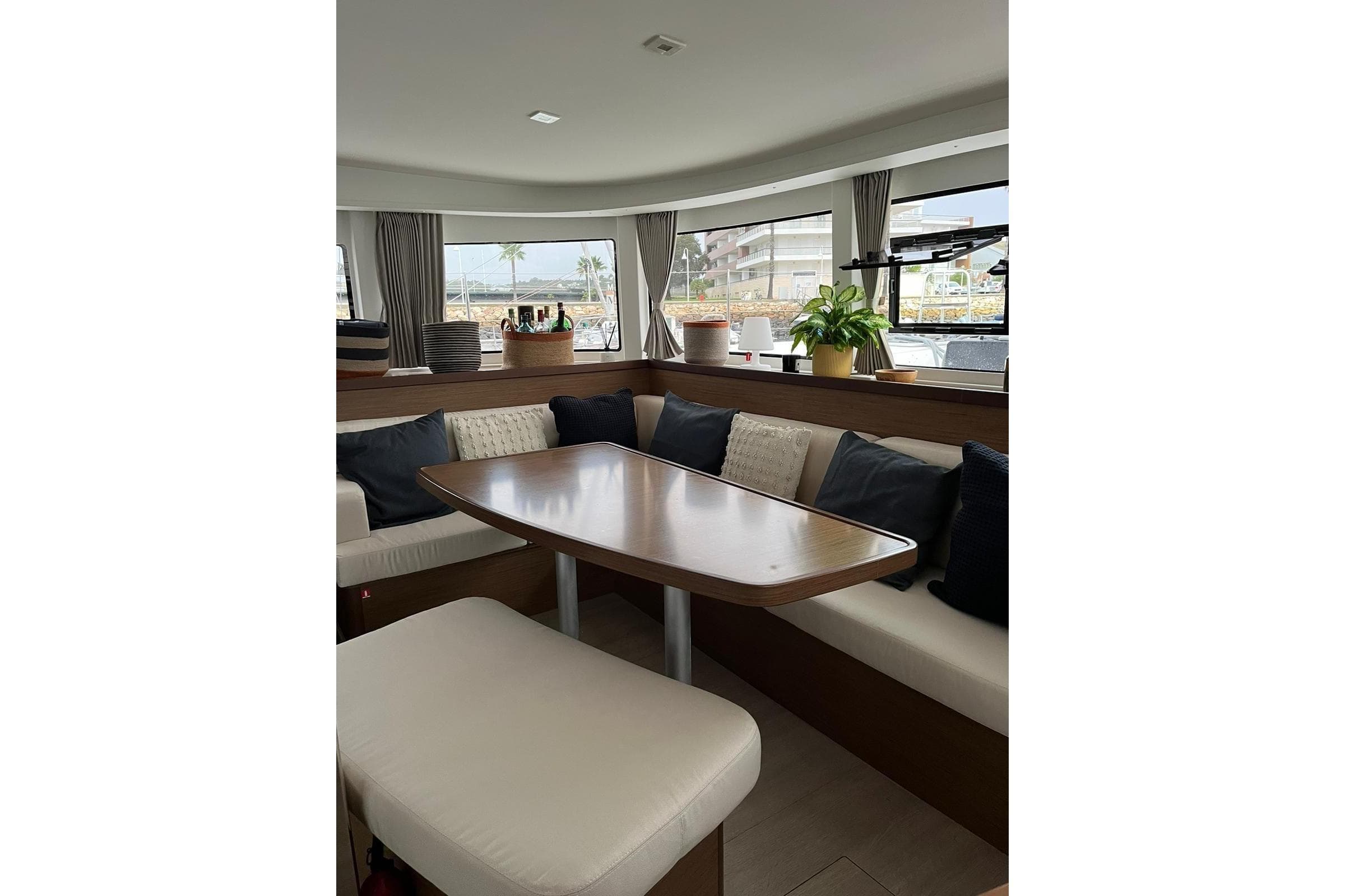 Interior of 2020 Lagoon 42 catamaran with cozy seating and dining area.
