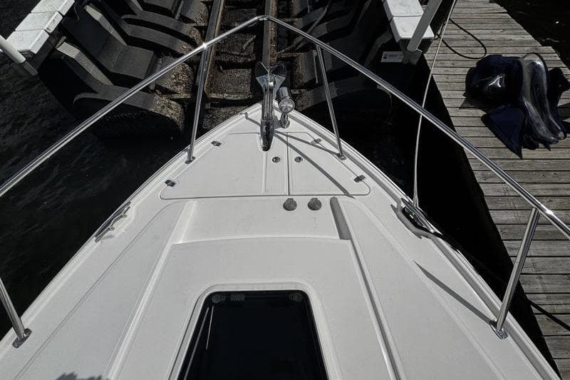 2018 Regal 35 Sport Coupe bow view at dock, featuring sleek design and stainless steel railings.