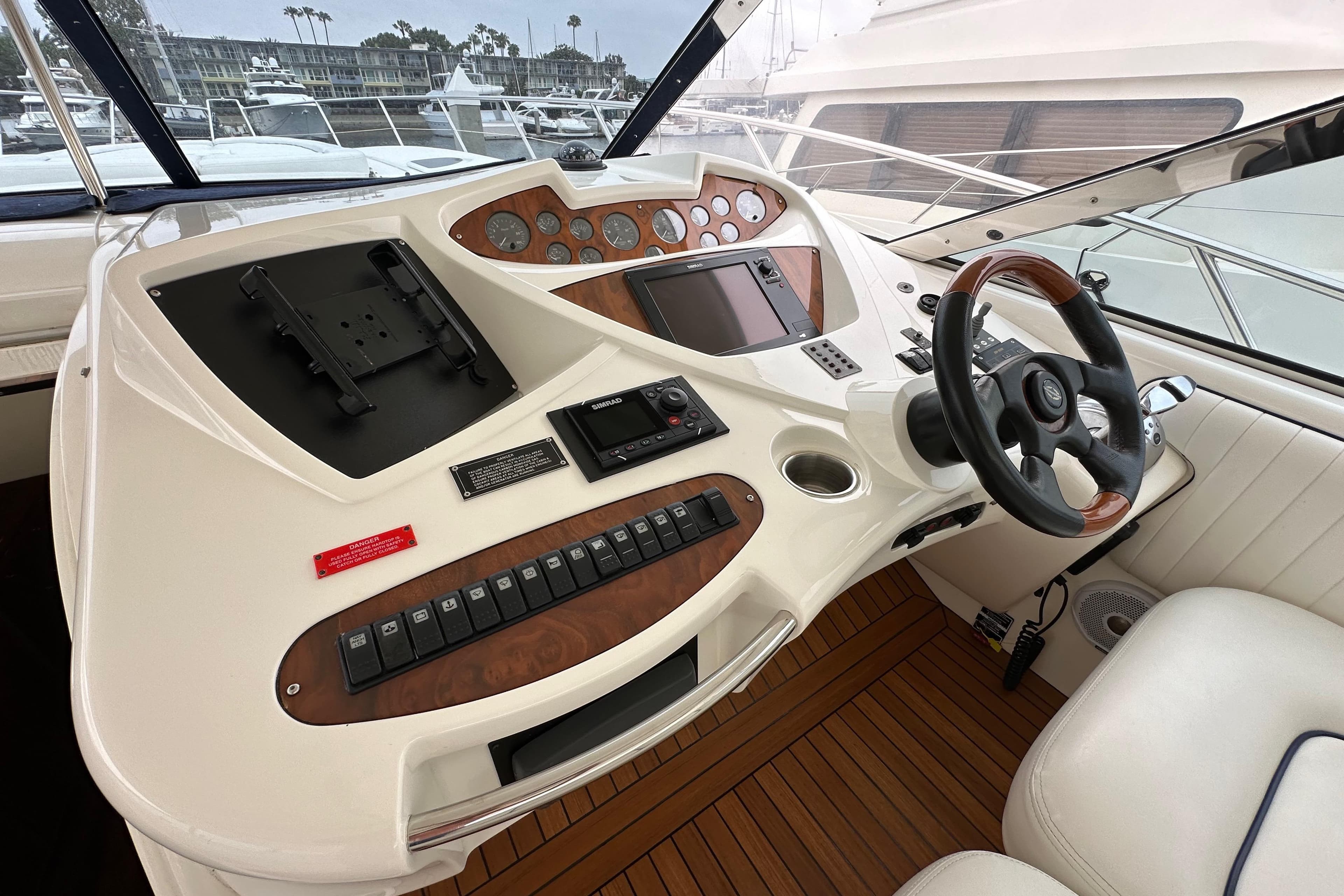 Cockpit of 2000 Sunseeker Predator 60 yacht with steering wheel and control panel.