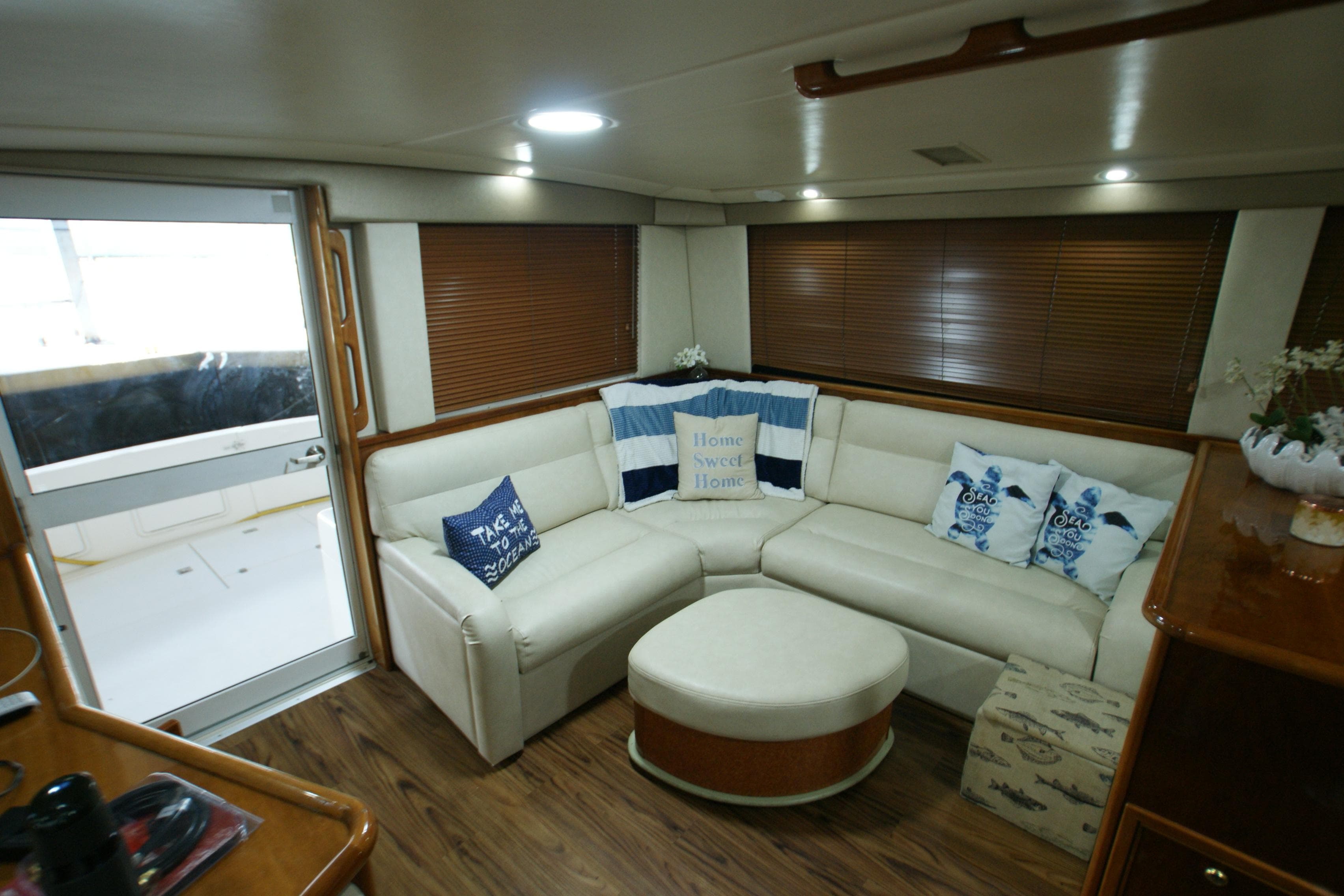 Interior of a 2000 Riviera 48 Convertible yacht with cozy sofa and cushions.