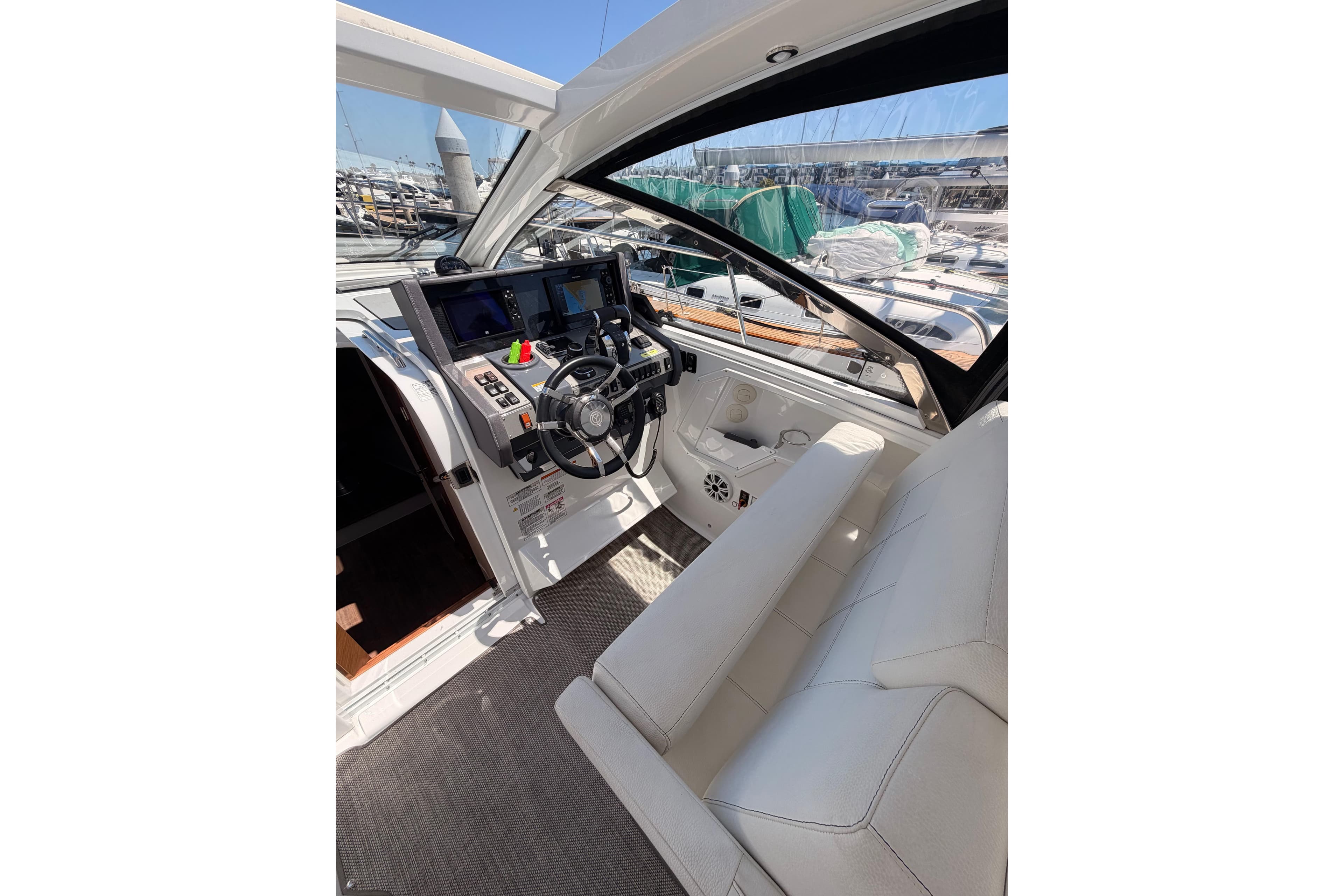 2020 Cruisers Yachts 390 Express Coupe cockpit with modern controls and plush seating.