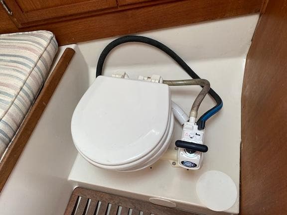 1979 Bayfield 29 boat interior with marine toilet and wooden accents.