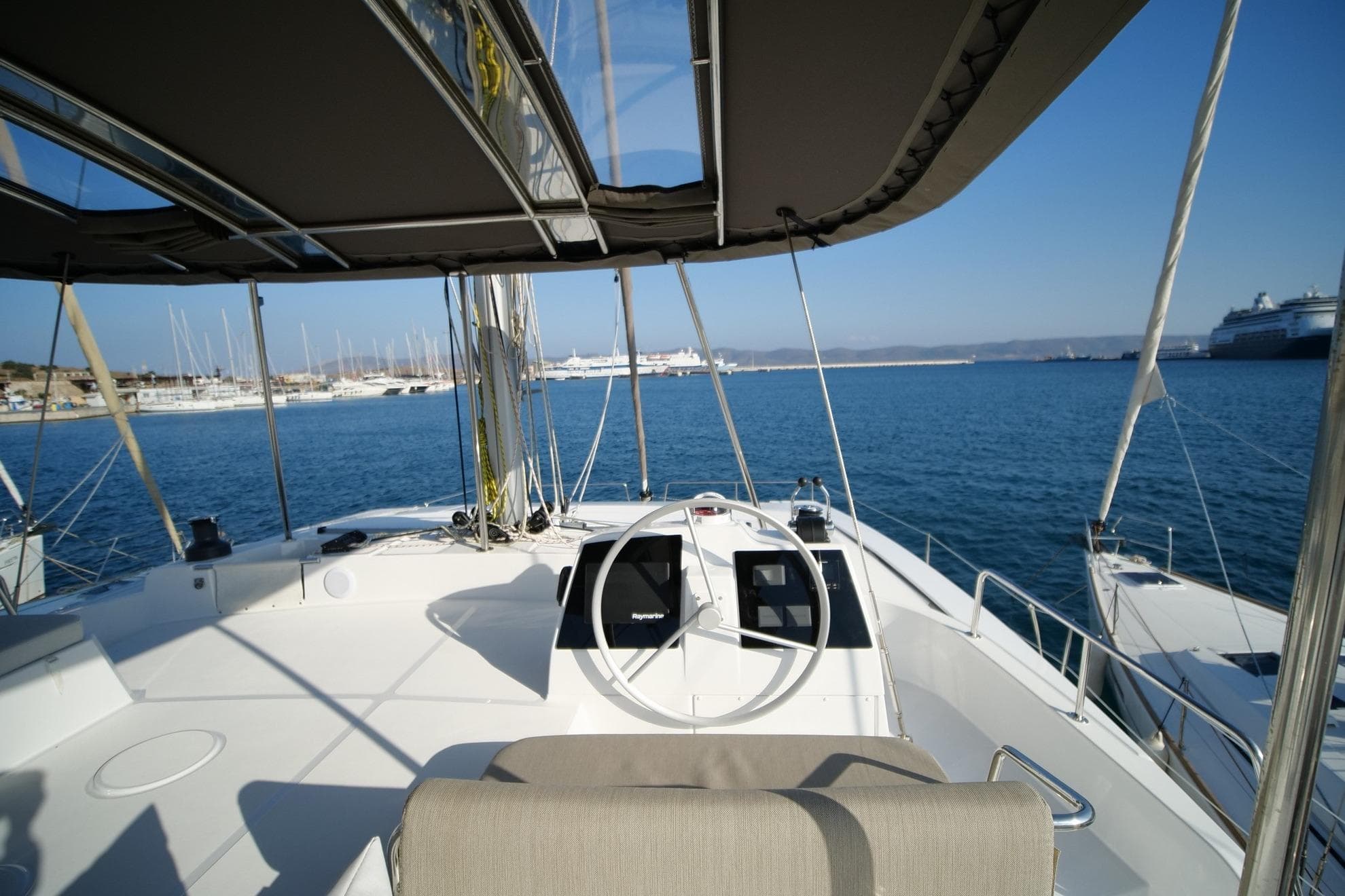 2022 Bali 4.8 catamaran cockpit with ocean view and marina backdrop.