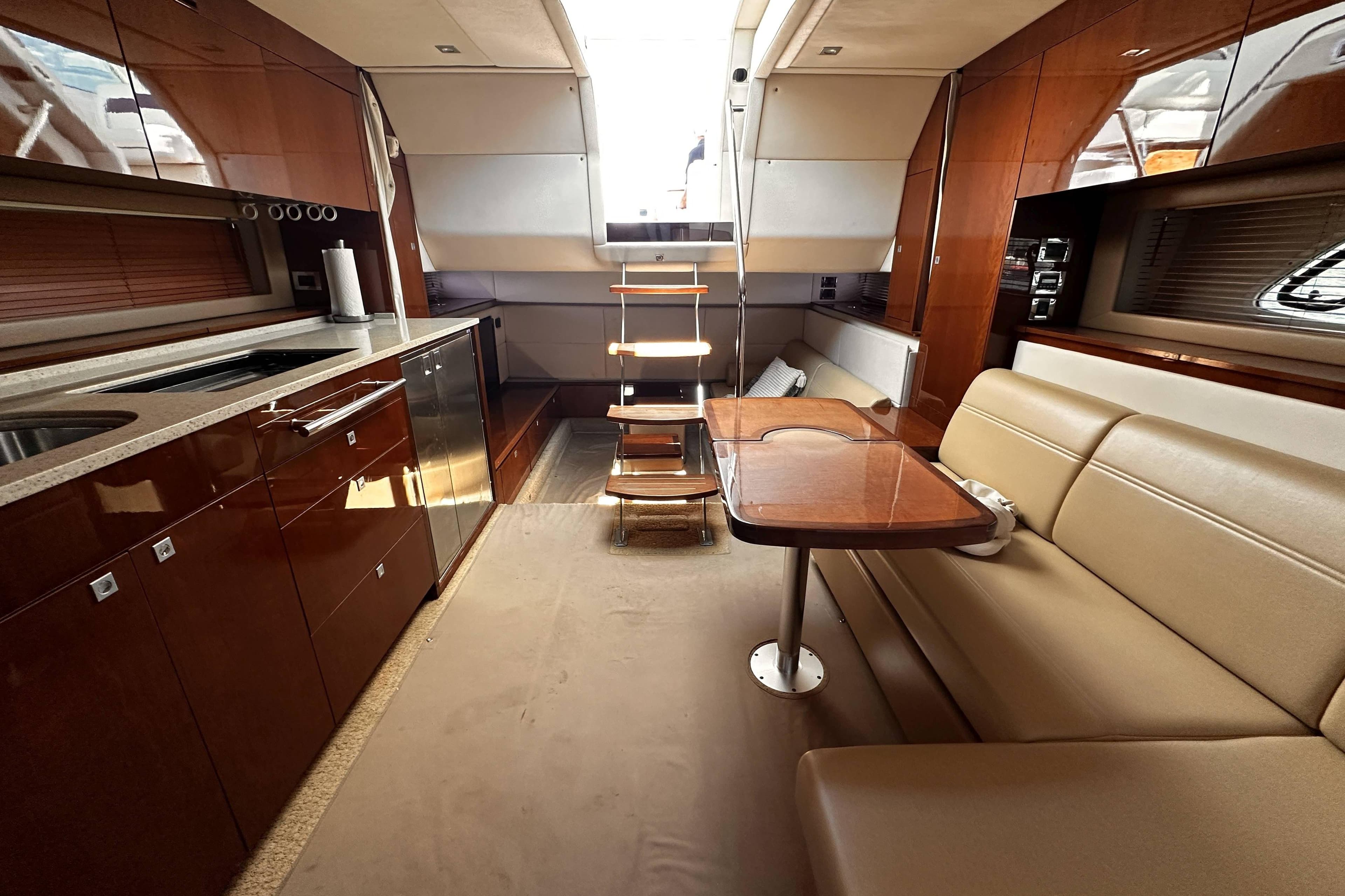 Luxurious interior of 2010 Sea Ray 450 Sundancer yacht with modern kitchen and seating area.