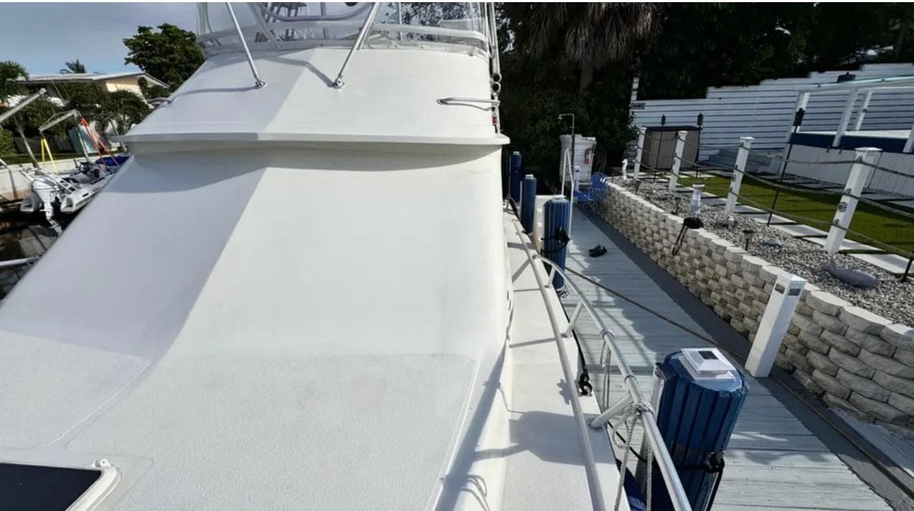1987 Blackfin Convertible boat docked, showing deck and railing details.