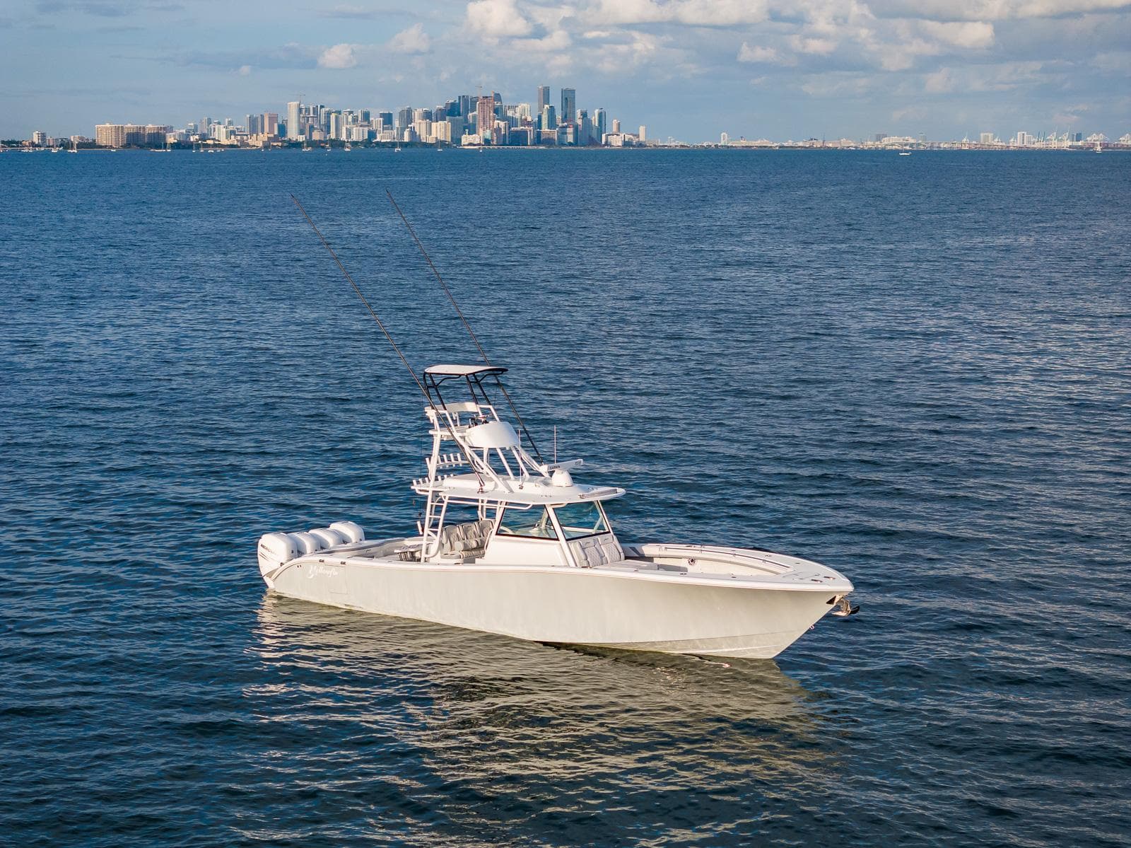 2022 Yellowfin 42 boat on open water with city skyline in the background.
