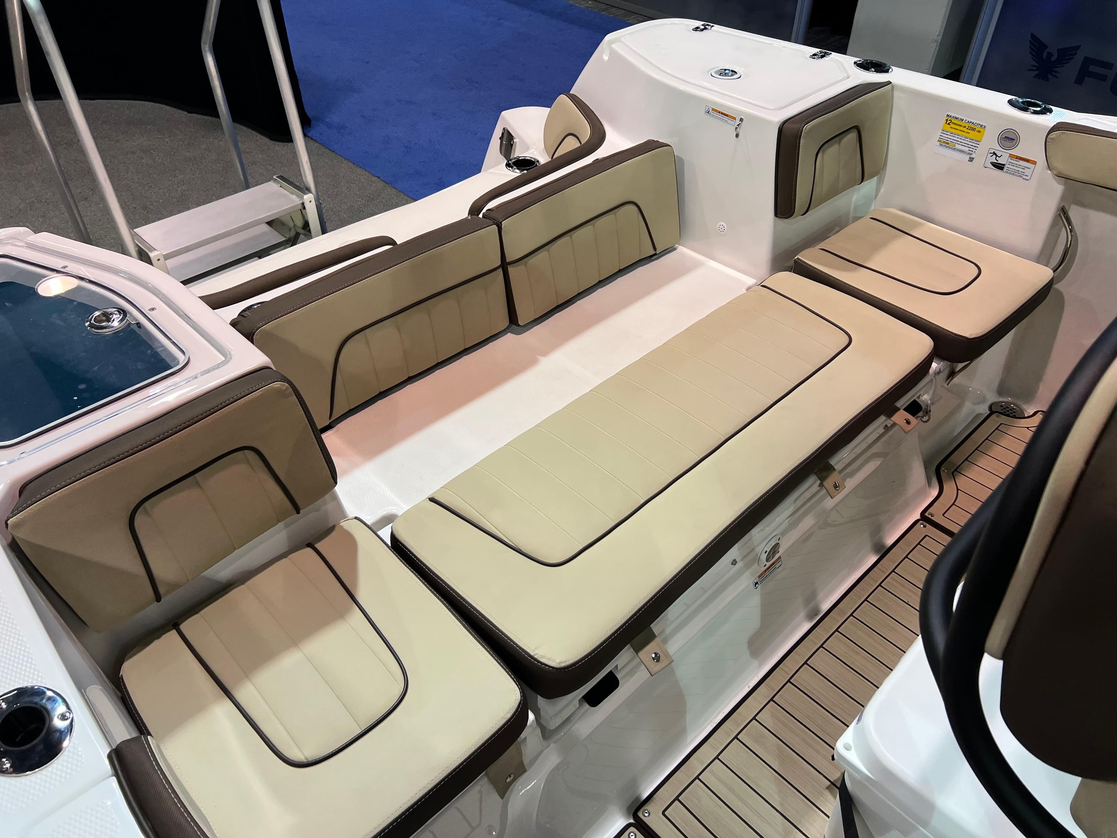 2025 Yamaha Boats 255 FSH Sport H interior seating with beige cushions.