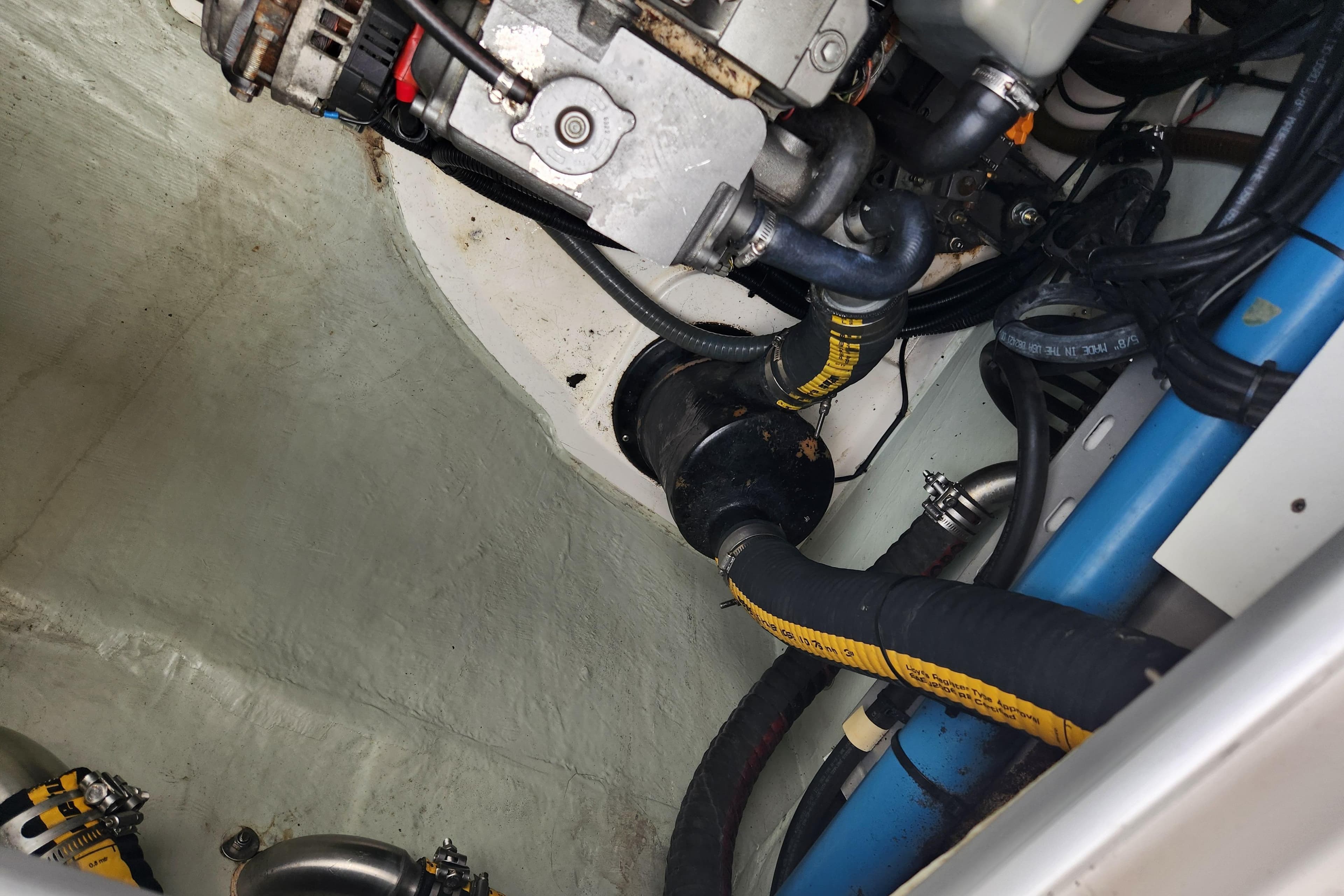 Engine compartment of a 2015 Leopard 44 boat with visible hoses and components.