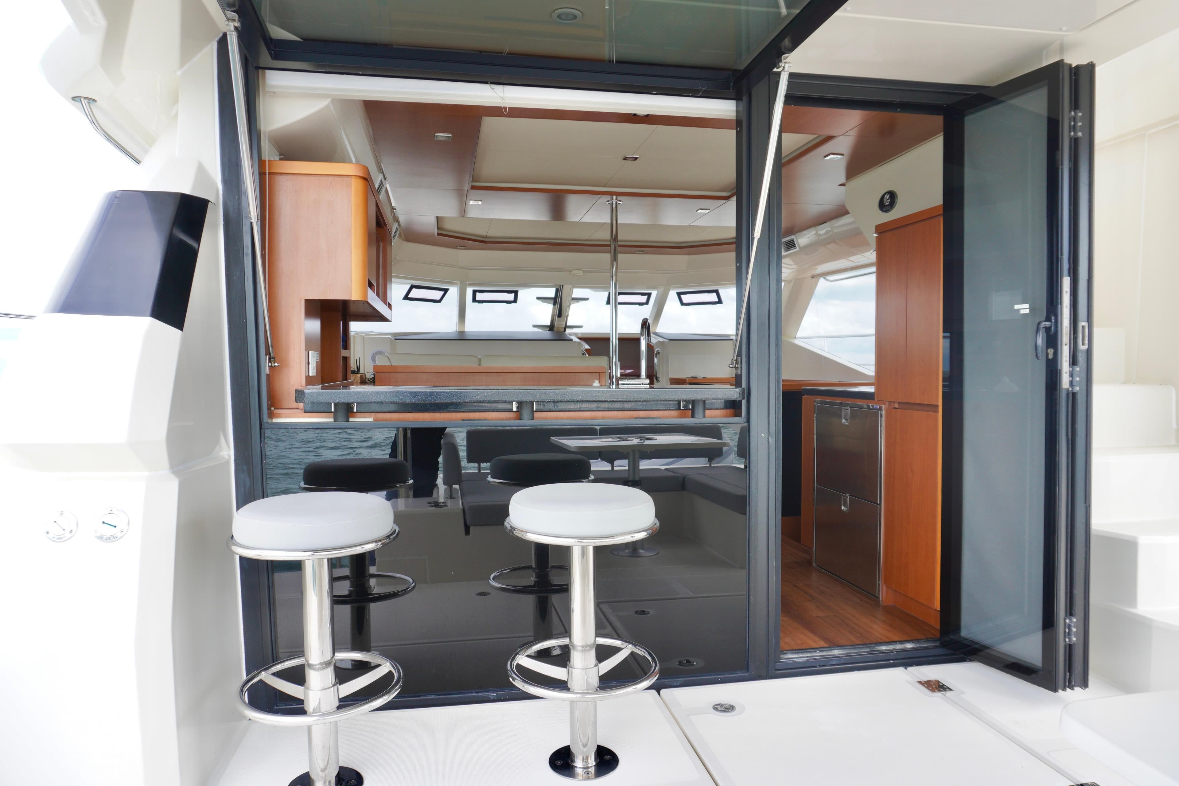 Interior view of 2017 Aquila 44 Yacht with modern seating and kitchen area.