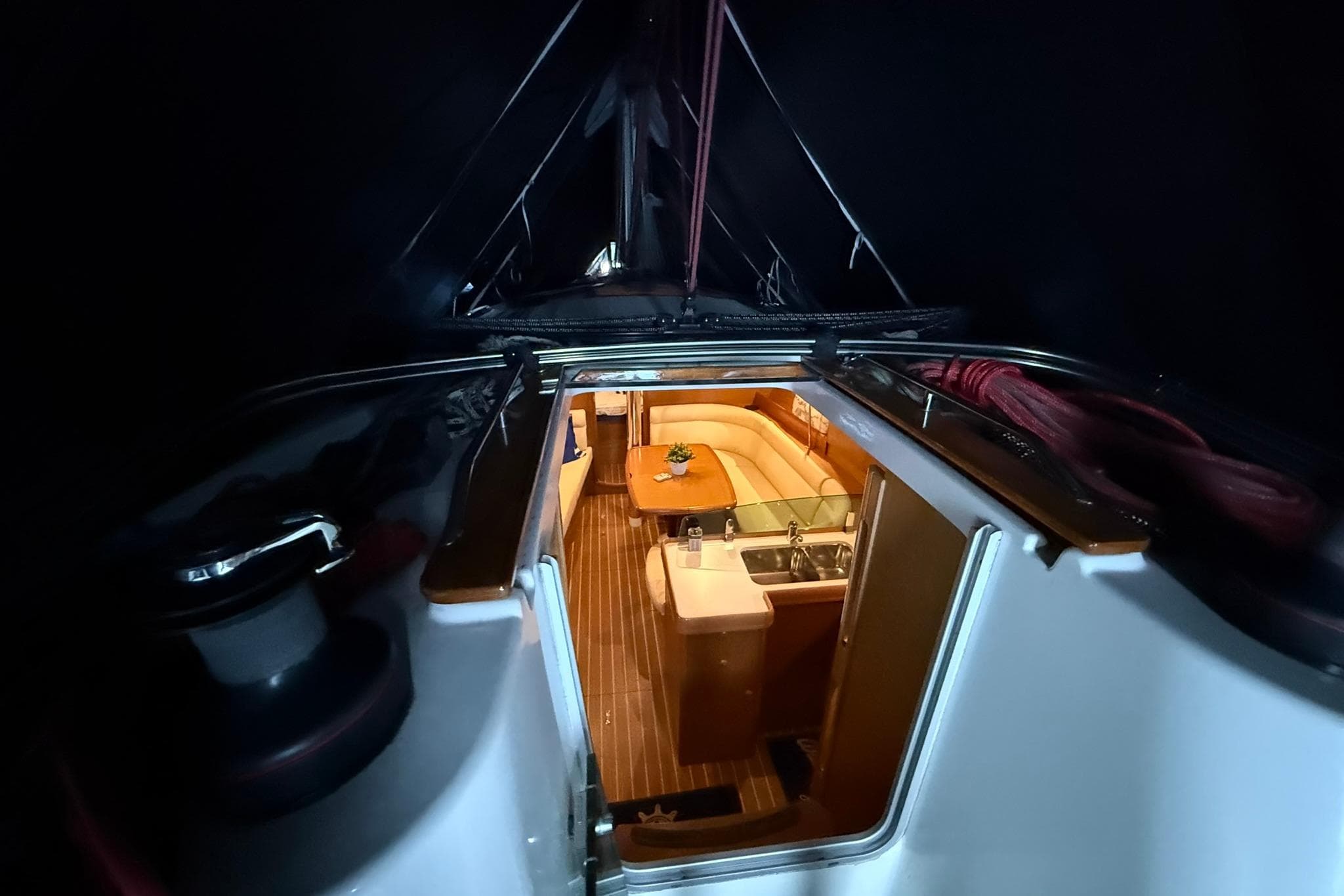 Interior view of 2007 Jeanneau Sun Odyssey 39i sailboat, featuring cozy seating and kitchen area.